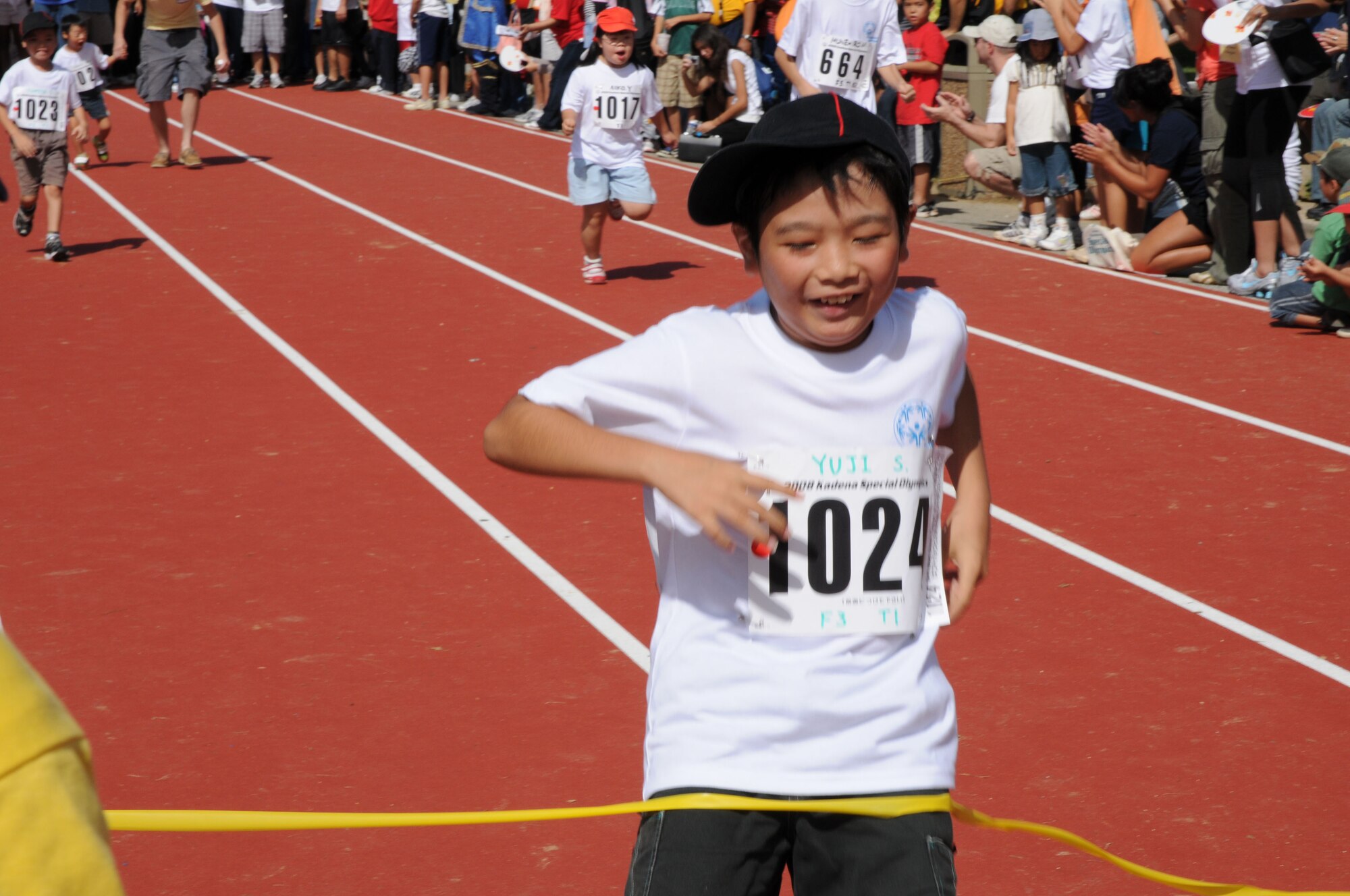 Yuji-san crosses the finish line after competing in the 30 meter dash during the Kadena Special Olympics Nov. 8, 2008, Kadena Air Base, Japan. Kadena hosted the 9th Annual Special Olympic Games and Art Festival for special needs Okinawan and American adult and child athletes.(U.S. Air Force photo/Airman 1st Class Amanda Grabiec)    
                                             