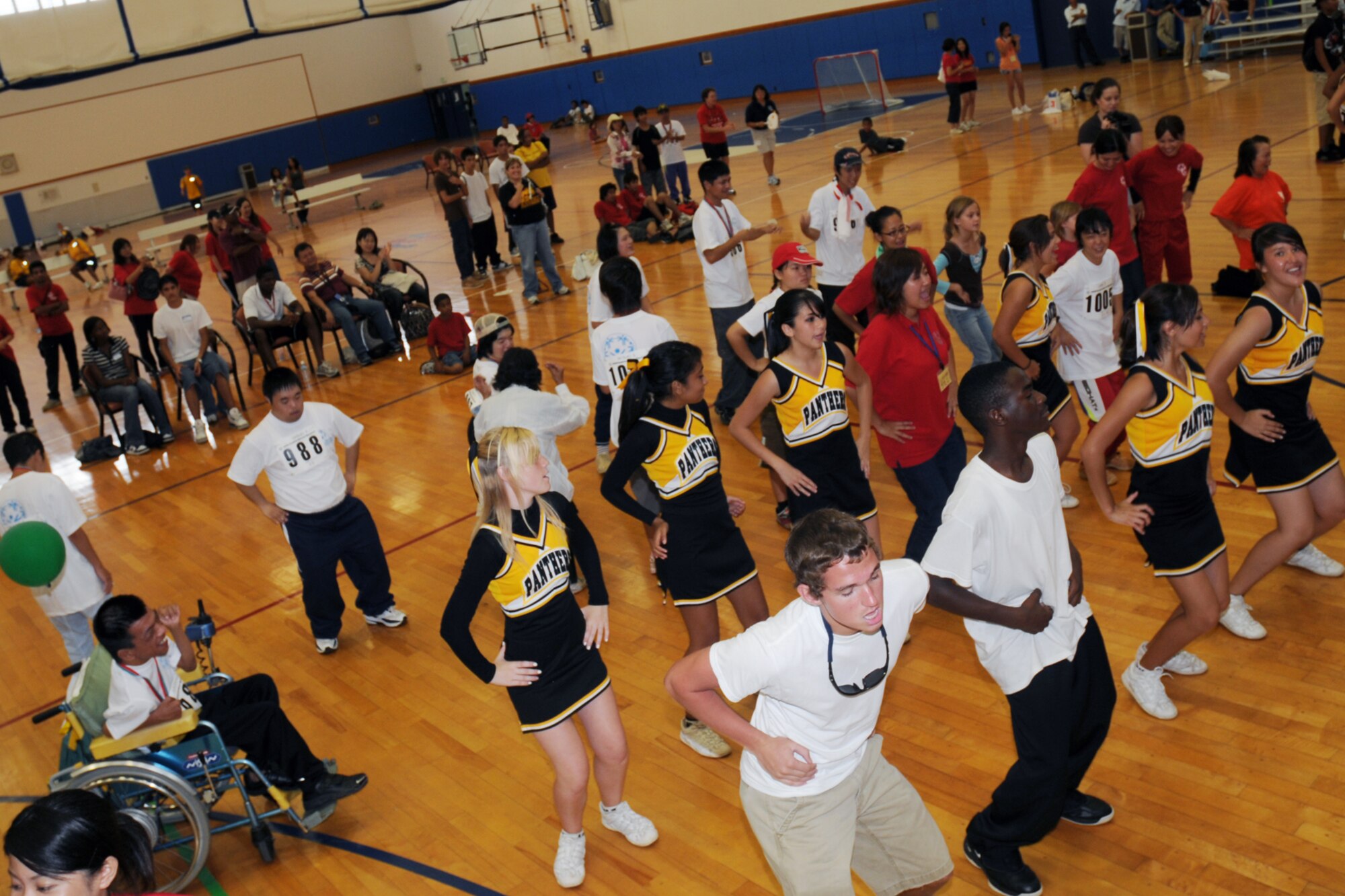 Special Olympic athletes, volunteers, and spectators join together to dance the Macarena in the Risner Fitness Center during the Kadena Special Olympics Nov. 8, 2008. Kadena Air Base hosted the 9th Annual Special Olympic Games and Art Festival for special needs Okinawan and American adult and child athletes. (U.S. Air Force photo/Airman 1st Class Chad Warren)
                                             