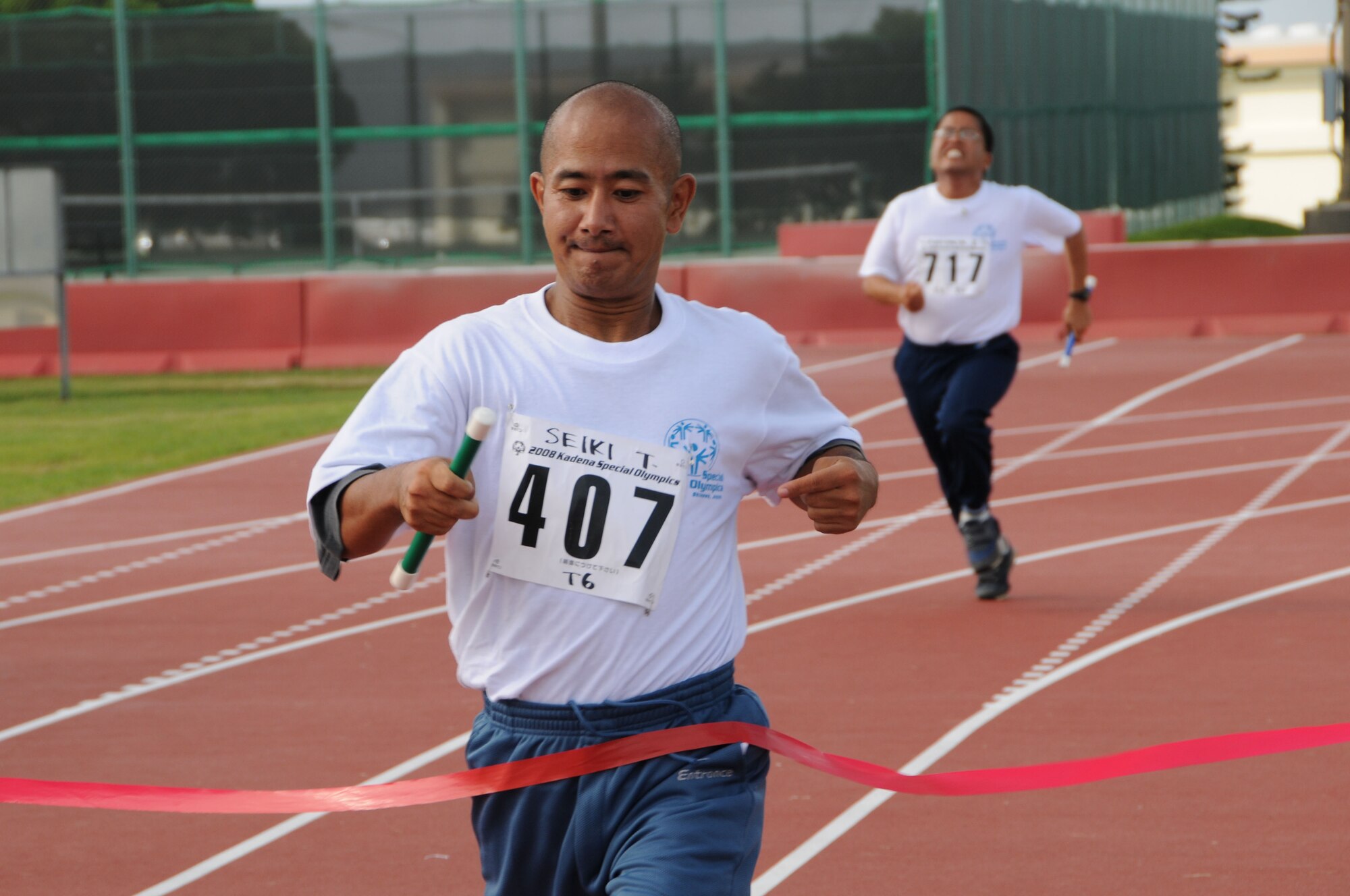 Seiki-san, a participant of the 400 meter relay, crosses the finish line during the 9th Annual Special Olympics hosted by Kadena Air Base, Japan Nov. 8, 2008.   (U.S. Air Force photo/Staff Sgt. Chrissy Best)   
                                             