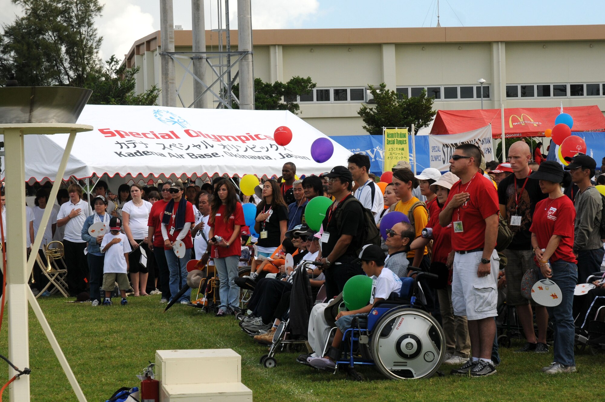 During the opening ceremony, Americans and Okinawans honor the Japanese and U.S. national anthems during the Special Olympics Games Nov. 8, 2008 at Kadena Air Base, Japan. Kadena hosted the 9th Annual Special Olympic Games and Art Festival for special needs Okinawan and American athletes. (U.S. Air Force photo/Staff Sgt. Chrissy Best) 