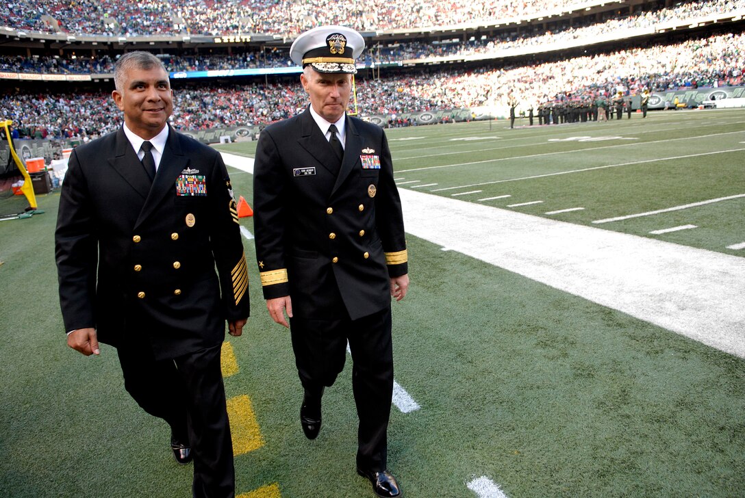 U.S. Navy Master Chief Petty Officer of the Navy Joe R. Campa Jr. and Rear Adm. Terence E. McKnight, Commander, Expeditionary Strike Group 2 walk along the sidelines at the Meadowlands during half time of the New York Jets and St. Louis Rams game on Military Appreciation Day. During half time, McKnight read the oath of enlistment for a group of future service members, East Rutherford, N.J., Nov. 9, 2008.