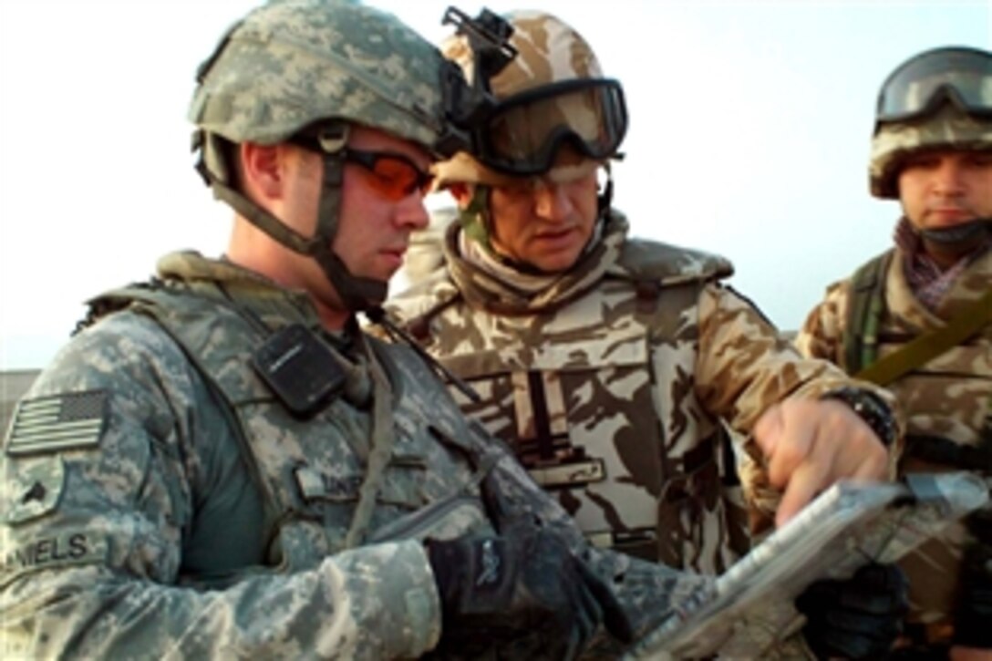 U.S. Army Sgt. Will Daniels compares notes with Romanian army Lt. Col. Vasile Vreme, the commander of the 341st Infantry Battalion, during an observation mission Nov. 4, 2008, near Nasiriyah, Iraq. Daniels is a forward observer in the Long Knife Brigade's combat observation and lasing team.