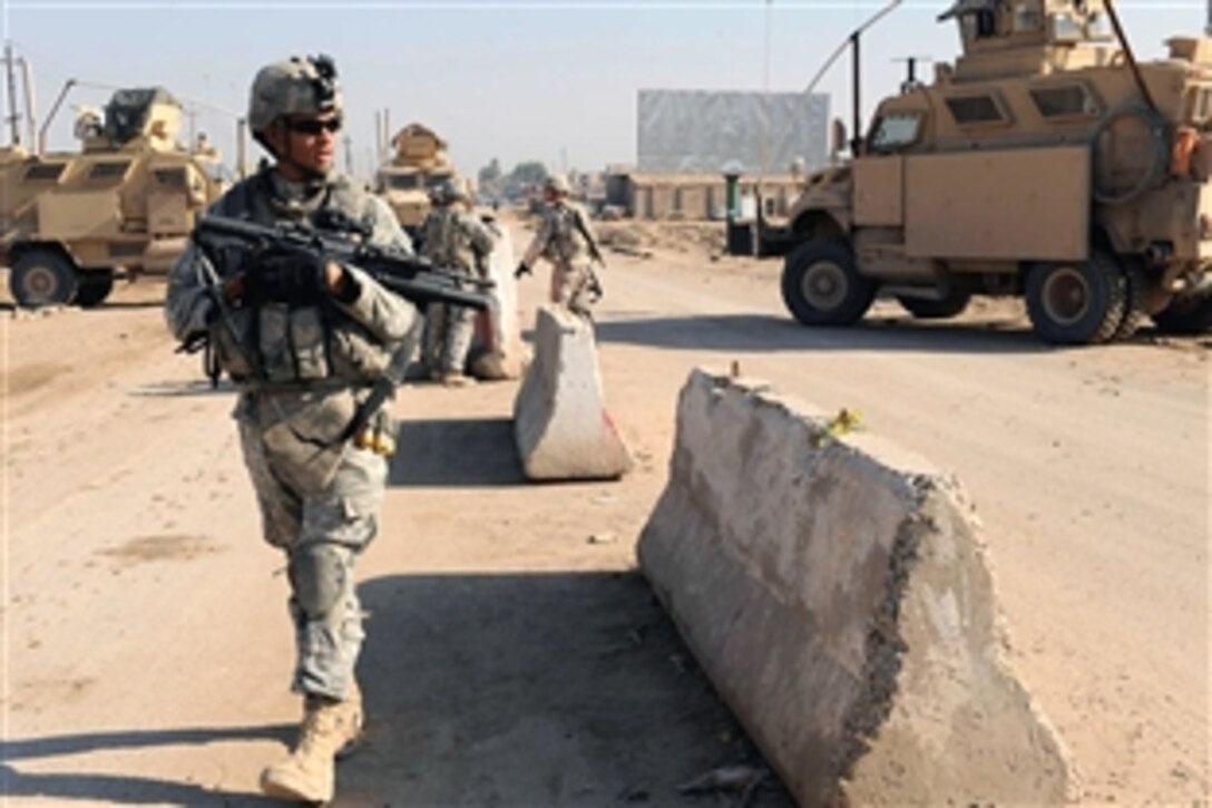 U.S. Army soldiers perform a presence patrol and check on security checkpoints in the area of  Hamadia, in the city of Baghdad, Iraq, Nov. 05, 2008. The soldiers are assigned to the 1st Armored Division's 2nd platoon, Company C, 2nd Brigade Combat Team.