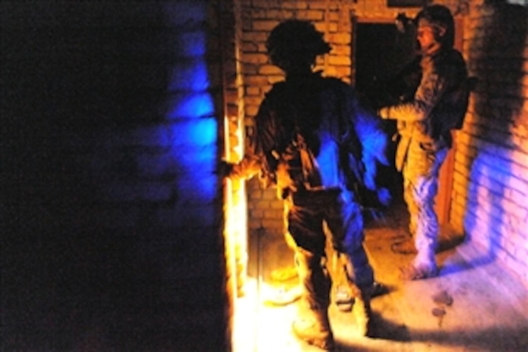 U.S. Army soldiers perform a search of houses during the evening in the area of Hamadia, in the city of Baghdad, Iraq, Nov. 04, 2008. The soldiers are assigned to the 1st Armored Division's 2nd Brigade Combat Team.