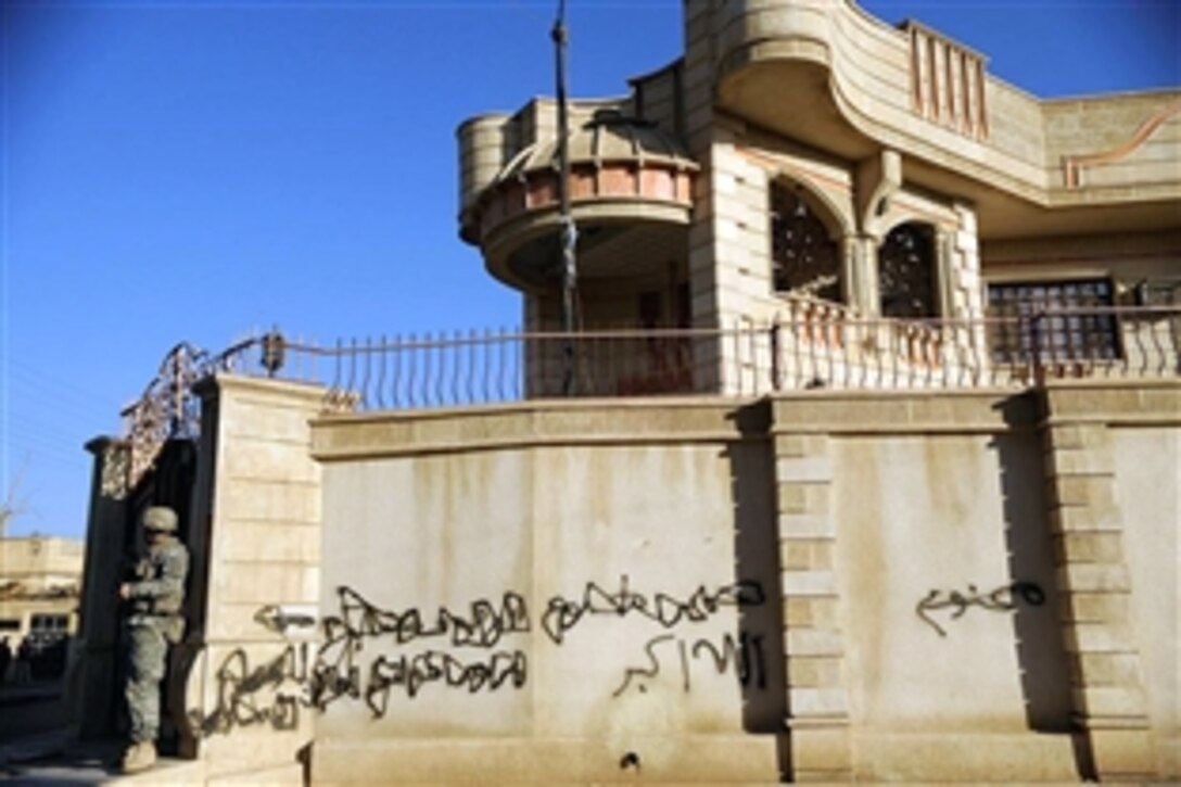 U.S. Army soldier provides over-watch security for Iraqi National Police officers conducting a cordon and "knock" mission to introduce themselves to the residents of Thawra neighborhood of Mosul, Iraq, Nov. 8, 2008. The soldiers are assigned to the  3rd Armored Cavalry Regiment's 3rd Squadron.