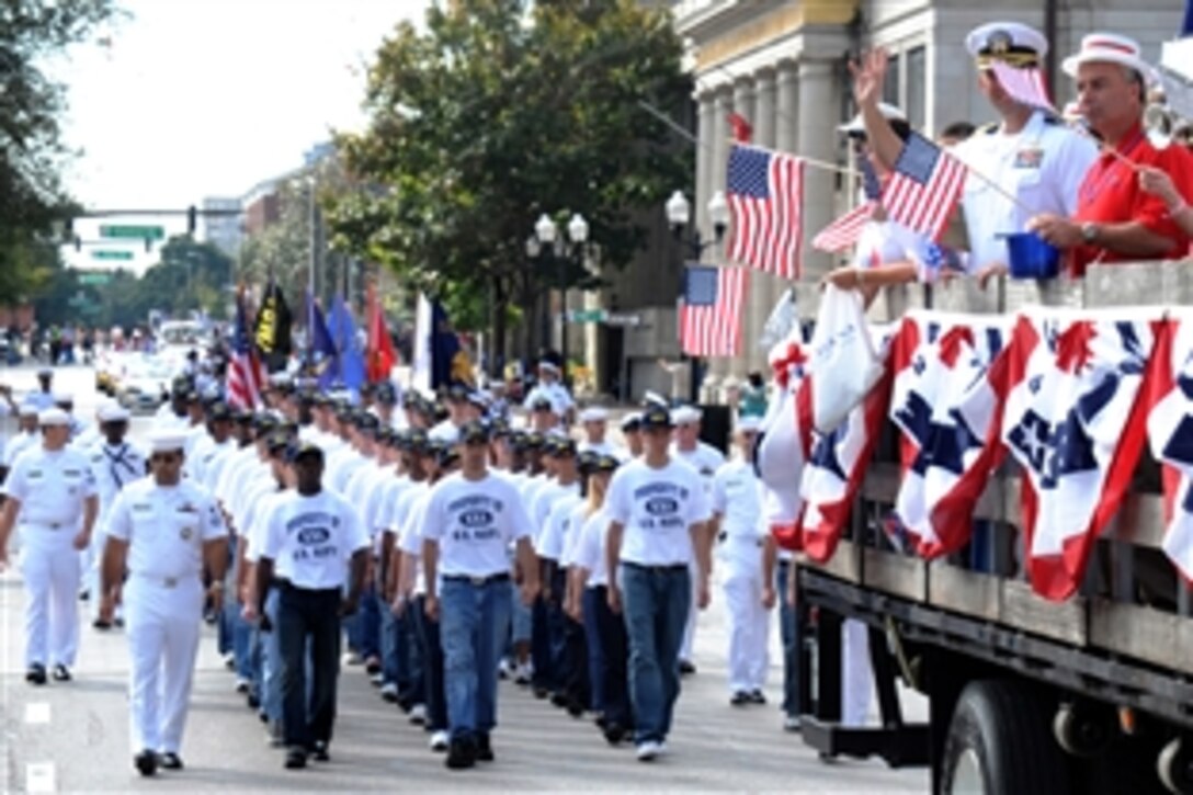A group of delayed entry program recruits follows behind a truck full of U.S. Navy sailors during the Veterans Day Parade, Orlando, Fla., Nov. 8, 2008. The parade was one of the main events in the Orlando Navy Week, which is designed to raise awareness of the service in metropolitan areas that do not have a significant Navy presence.