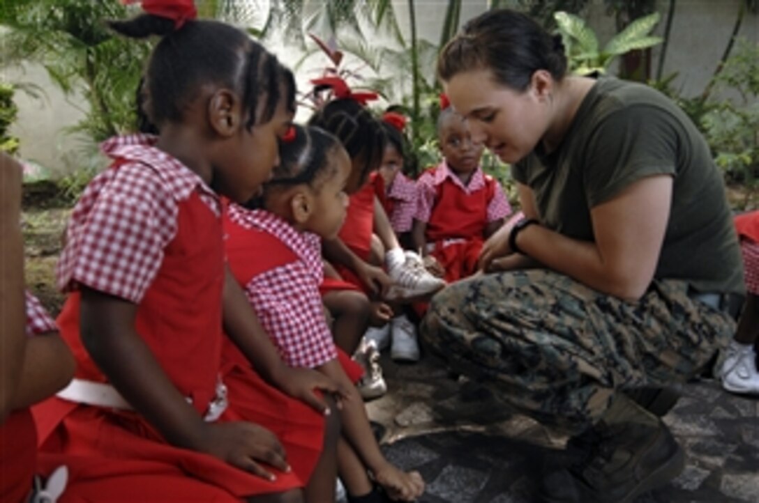 U.S. Marine Corps Lance Cpl. Mary Hojek, embarked aboard the USS Kearsarge (LHD 3), uses her lunch break to interact with children at the St. Jude's School for Girls during the humanitarian and civic assistance mission Continuing Promise 2008 in Port of Spain, Trinidad and Tobago, on Nov. 5, 2008.  The Kearsarge is supporting the Caribbean phase of Continuing Promise 2008, an equal-partnership mission between the United States, Canada, the Netherlands, Brazil, Nicaragua, Colombia, Dominican Republic, Trinidad and Tobago and Guyana.  