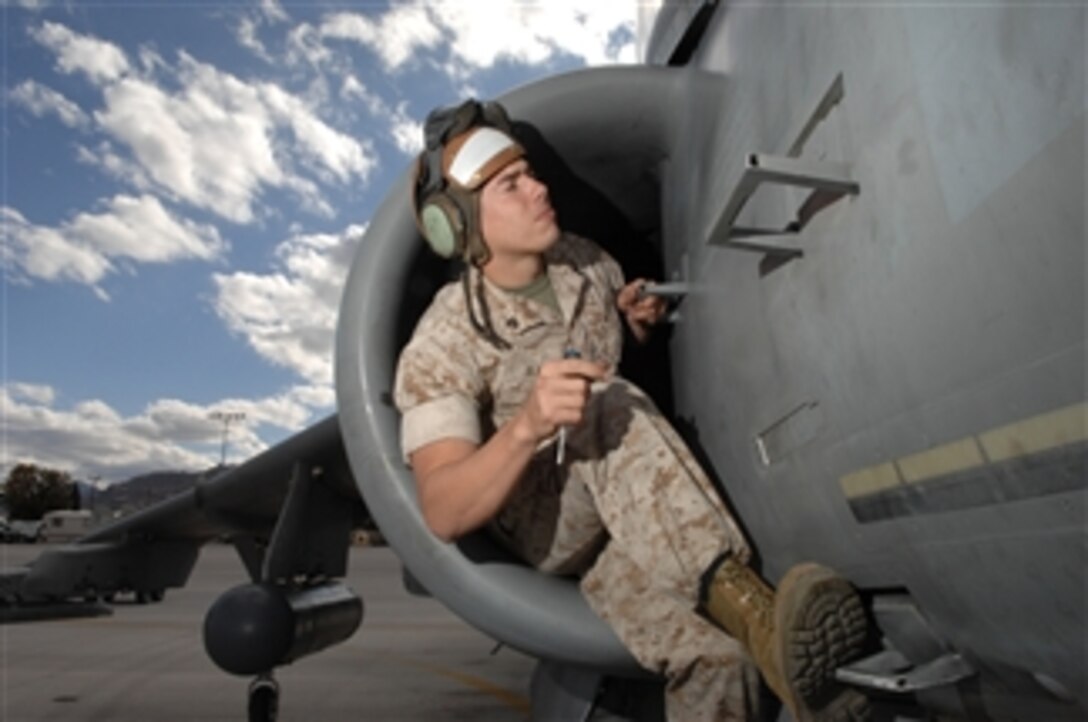 U.S. Marine Corps Sgt. Jacob Black, an AV-8B Harrier aircraft power line mechanic assigned to Marine Attack Squadron 513 inspects his aircraft prior to take off from Creech Air Force Base, Nev., on Nov. 4, 2008.  The Marines are executing joint and high-altitude forward base operations alongside MQ-1 Predator unmanned aerial vehicles in preparation for deployment to Southwest Asia.  