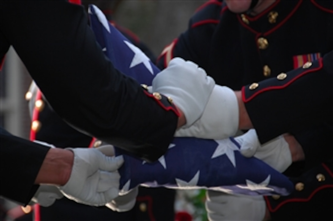 U.S. Marines from Marine Barracks Washington, D.C., fold a flag during the funeral ceremony for former Commandant of the Marine Corps Gen. Robert H. Barrow in Saint Francisville, La., on Nov. 3, 2008.  