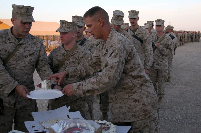 Marines and sailors line up to receive a slice of the birthday cake commemorating the 233rd anniversary of the birth of the Marine Corps, Nov. 10.
