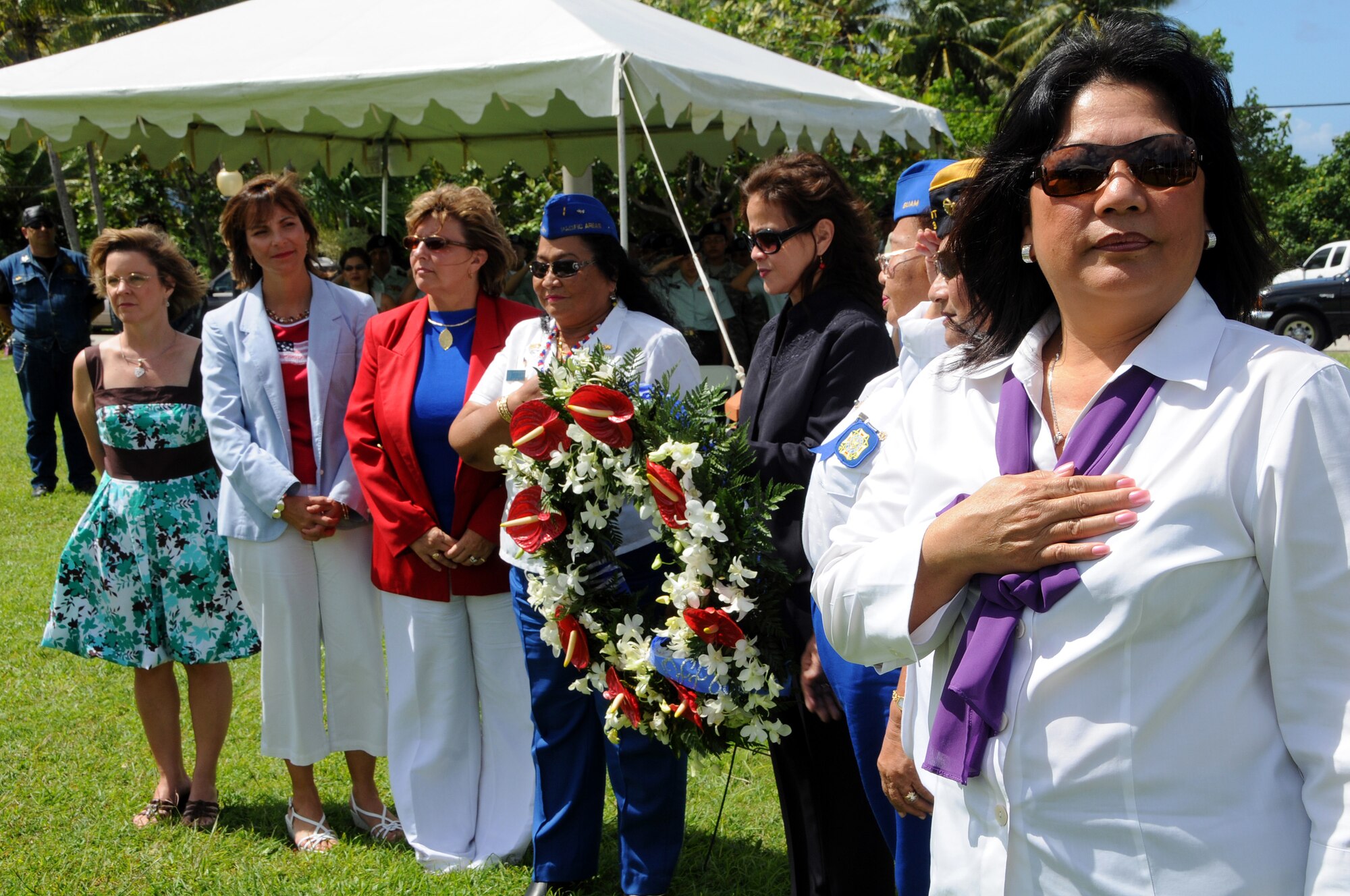 ANDERSEN AIR FORCE BASE, Guam - Mrs. Lina Ruhlman, second from the left, stands with distinguished female guests while taps plays in the background during the the Veterans Day Ceremony at the Ricardo J. Bordallo Governors Complex in Adelup, Guam Nov. 11. 