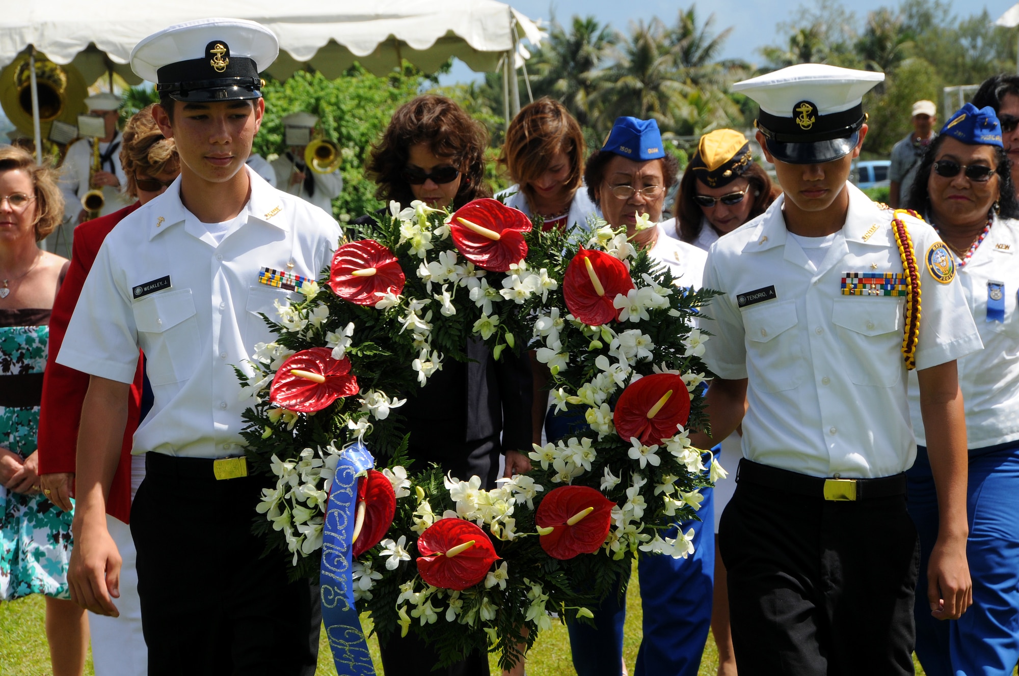 ANDERSEN AIR FORCE BASE, Guam - Naval Junior Reserve Officers Training Corps Cadets carry the wreath to its final resting place during the the Veterans Day Ceremony at the Ricardo J. Bordallo Governors Complex in Adelup, Guam Nov. 11. Distinguished female guests follow behind to help lay the wreath. (U.S. Air Force photo by Airman 1st Class Courtney Witt) 
