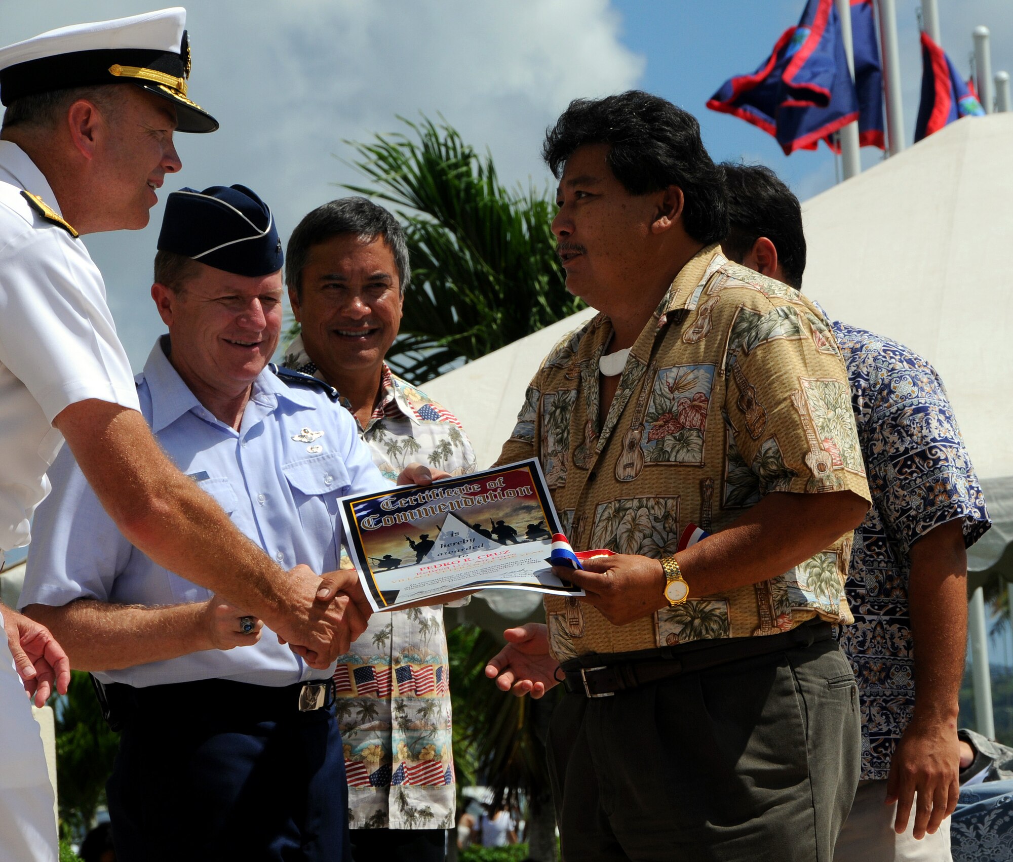 ANDERSEN AIR FORCE BASE, Guam - Pedro Cruz, a retired Air Force veteran, accepts an award from Rear Adm. William French for Village Veteran of the Year during the the Veterans Day Ceremony at the Ricardo J. Bordallo Governors Complex in Adelup, Guam Nov. 11. Each village was represented with a Veteran of the Year. (U.S. Air Force phtoto by Airman 1st Class Courtney Witt)