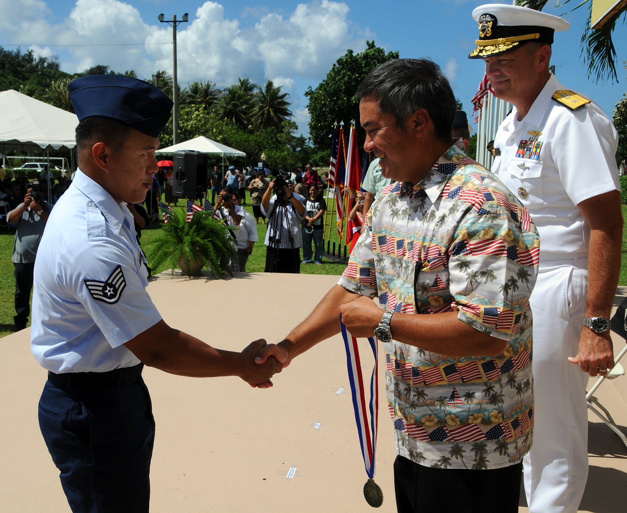 ANDERSEN AIR FORCE BASE, Guam - Staff Sgt. Francis Tagalog, 36th Civil Engineer Fire and Emergency Services Flight, shook hands with Gov. Felix Camacho as he accepts his Airman of the Year medal during the the Veterans Day Ceremony at the Ricardo J. Bordallo Governors Complex in Adelup, Guam Nov. 11. Each branch was represented by a top performer during the ceremony. (U.S. Air Force photo by Airman 1st Class Courtney Witt)
