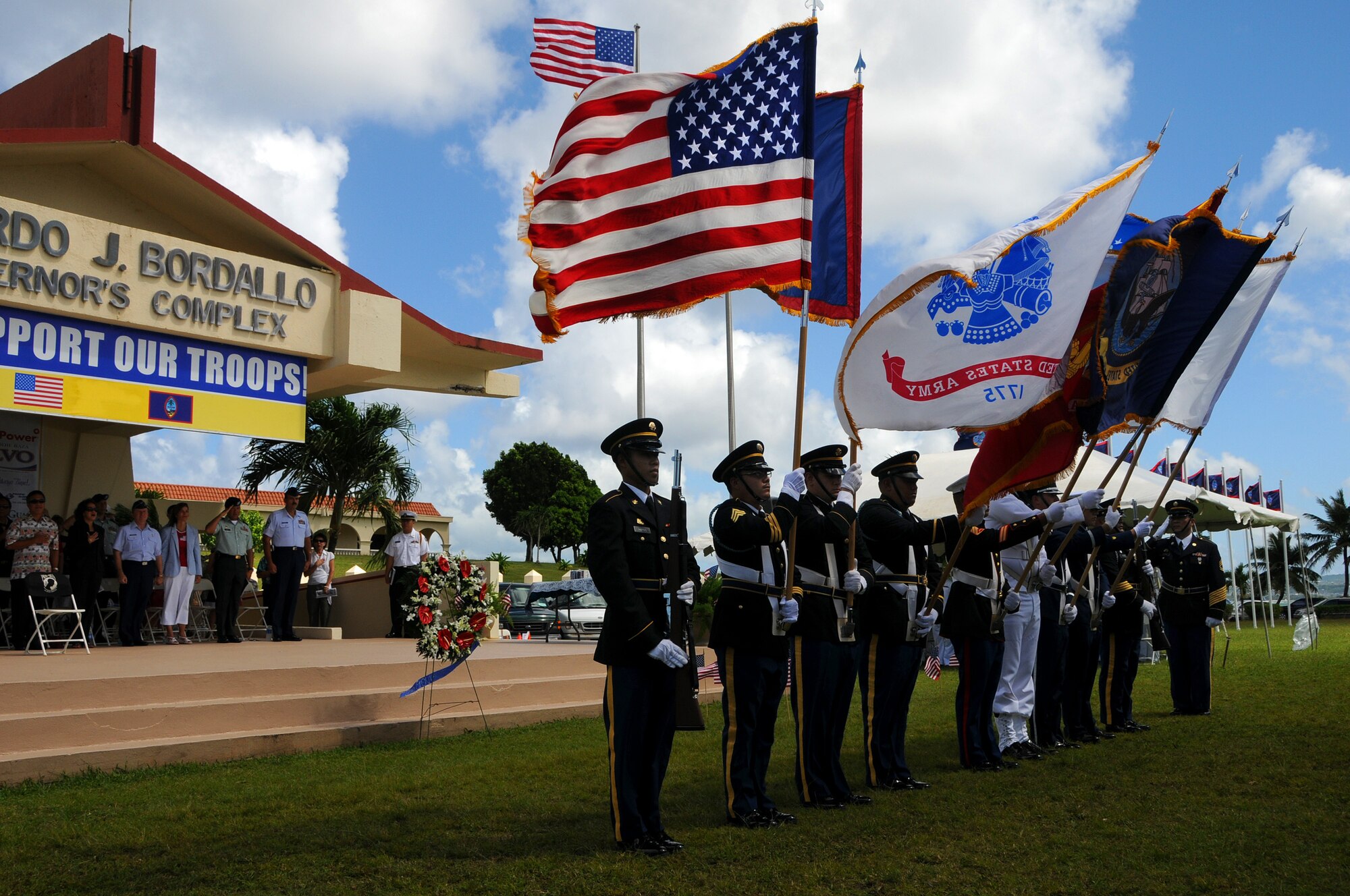 ANDERSEN AIR FORCE BASE, Guam - Joint Honor Guardsmen post the colors during the playing of our National Anthem during the Veterans Day Ceremony at the Ricardo J. Bordallo Governors Complex in Adelup, Guam Nov. 11.  Americans can reflect on the foresight, courage and sacrifices of past leaders and heroes and remember the courage and sacrifices of today's Soldiers, Sailors, Marines, Airmen, and Coast Guardsmen, who are fighting for freedom and providing humanitarian relief at home and overseas.(U.S. Air Force photo by Airman 1st Class Courtney Witt)