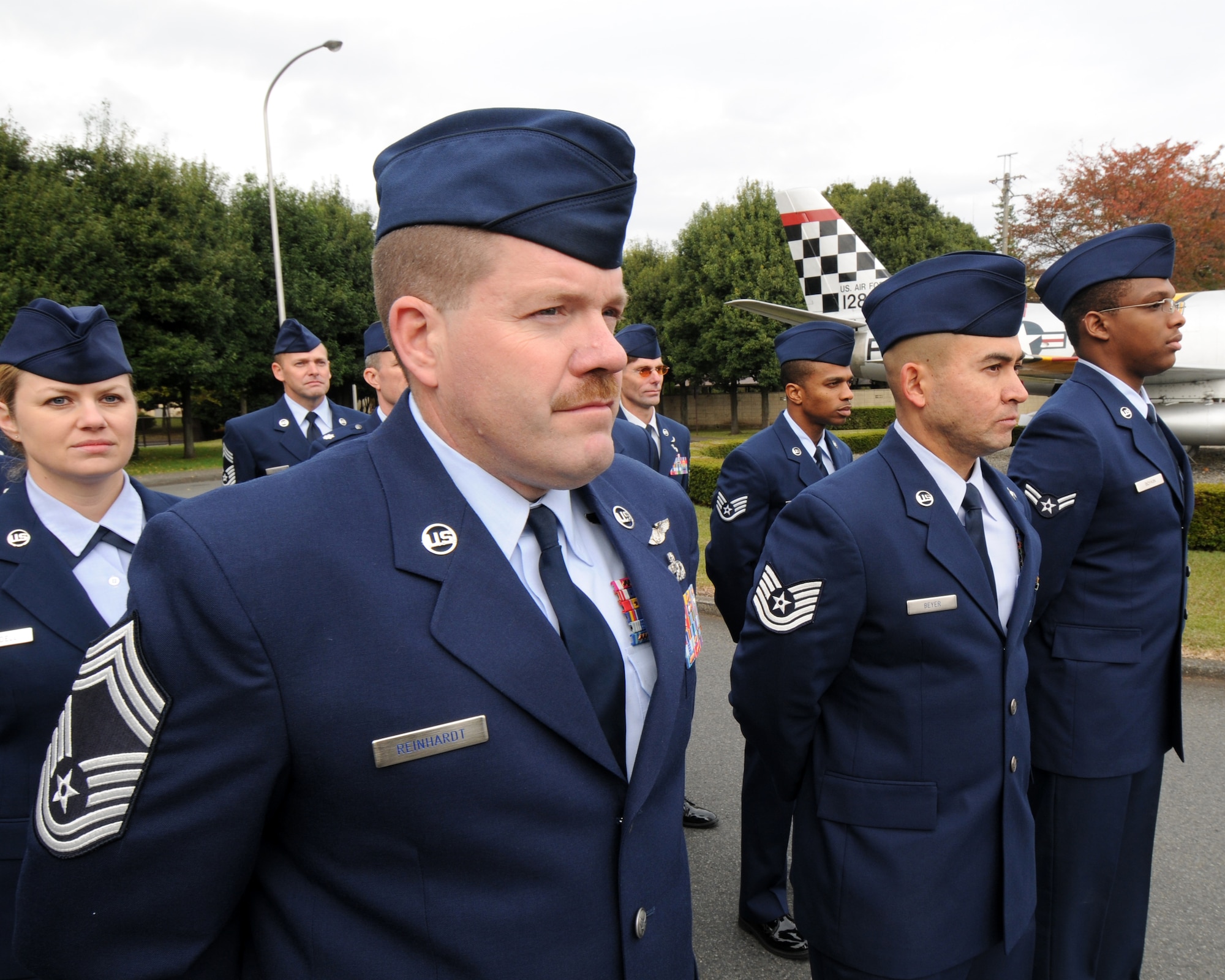 YOKOTA AIR BASE, Japan -- Chief Master Sgt. William Reinhardt (left) and other Airmen stand in formation Nov. 11 during the Veterans Day ceremony sponsored by the Yokota chapter of the Veterans of Foreign Wars.  It was one of two ceremonies held here. The other was conducted by the local chapter of the American Legion. Chief Reinhardt is assigned to the 374th Operations Group. (U.S. Air Force photo by Senior Airman Laszlo Babocsi)