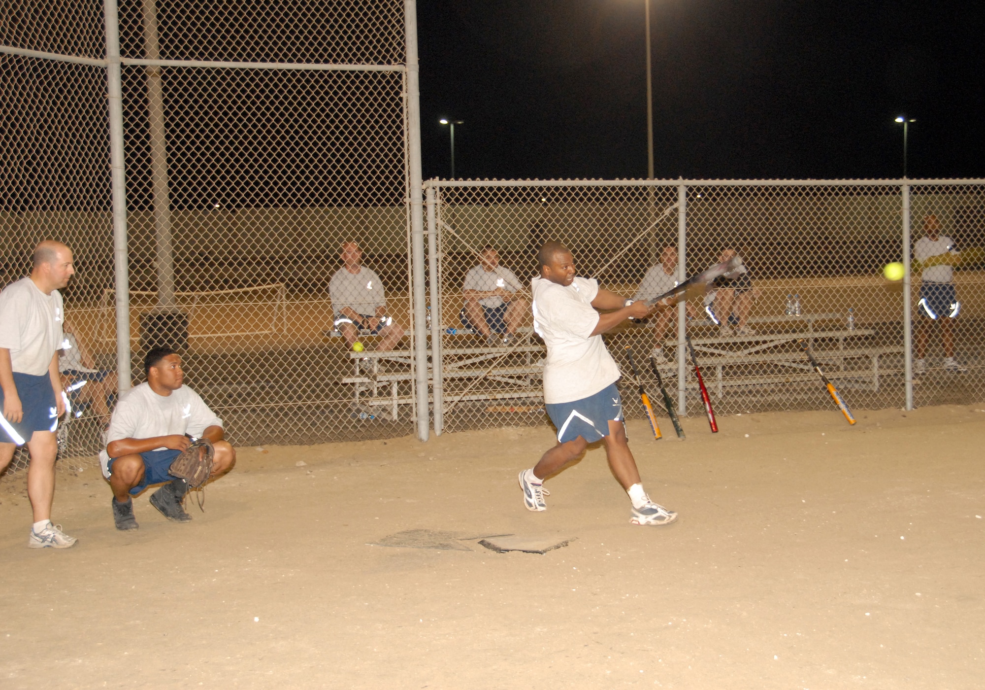 SOUTHWEST ASIA -- Jason Session hits a line drive down third-base line in a softball tournament here Nov. 8. The Civil Engineers defeated the Office of Special Investigations conglomerate, 18-12, during the championship game in the 380th Air Expeditionary Wing Combined Federal Campaign Softball Tournament. Proceeds were dontated to the USO through the CFC. (U.S. Air Force photo by Tech. Sgt. Denise Johnson)(released)