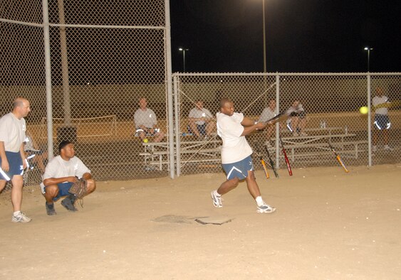 SOUTHWEST ASIA -- Jason Session hits a line drive down third-base line in a softball tournament here Nov. 8. The Civil Engineers defeated the Office of Special Investigations conglomerate, 18-12, during the championship game in the 380th Air Expeditionary Wing Combined Federal Campaign Softball Tournament. Proceeds were dontated to the USO through the CFC. (U.S. Air Force photo by Tech. Sgt. Denise Johnson)(released)