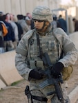 Airman 1st Class Israel Garza provides security near a checkpoint at Joint Base Balad, Iraq, Nov. 11. He was named the 332nd Air Expeditionary Wing's Tuskegee Airman of the Week for his actions during a security incident and protecting Iraqi officials and other distinguished visitors during a recent Iraqi-Based Industrial Zone ceremony on base. Garza, a security forces apprentice with the 532nd Expeditionary Security Forces Squadron, is deployed from Lackland Air Force Base, Texas. (U.S. Air Force photo/Tech. Sgt. Erik Gudmundson)