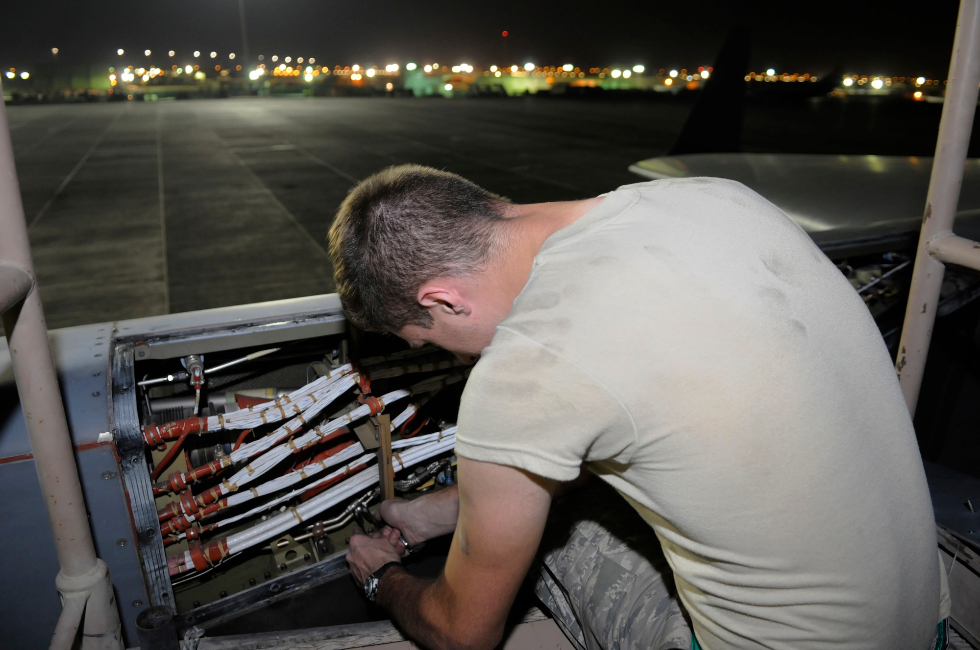 Airman 1st Class Eren Kipp, aircraft electrical & environmental systems technician assigned to the 8th Expeditionary Air Mobility Squadron, reconnects a shut-off valve connection on a C-17 Globemaster III engine, Nov. 10, at an undisclosed air base in Southwest Asia.  The AEES team is trouble shooting a valve that is telling the engine computer you one thing but a physical inspection shows otherwise.  The C-17 is capable of rapid strategic delivery of troops and all types of cargo to main operating bases or directly to forward bases in the Central Command Area of Responsibility.  Airman Kipp is deployed from Charleston Air Force Base, S.C., in support of Operations Iraqi and Enduring Freedom and Joint Task Force Base-Horn of Africa.  (U.S. Air Force photo by Tech. Sgt. Michael Boquette/Released)