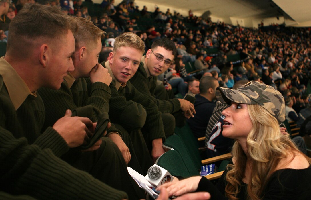 Dina Tsiorvas, the Arena Hostess for the New York Islanders Hockey Team, speaks to Marines with Weapons Company, Battalion Landing Team, 3rd Battalion, 2nd Marine Regiment, 22nd Marine Expeditionary Unit, inside the Nassau Veterans Memorial Coliseum during an Islanders vs. Philadelphia Flyers hockey game Nov. 11, 2008. The Marines attended the Military Appreciation Day with the New York Islanders as part of a visit to support Veterans Day and the Intrepid Sea, Air and Space Museum reopening. ::r::::n::(Official Marine Corps photo by Cpl. Justin M. Martinez)::r::::n::