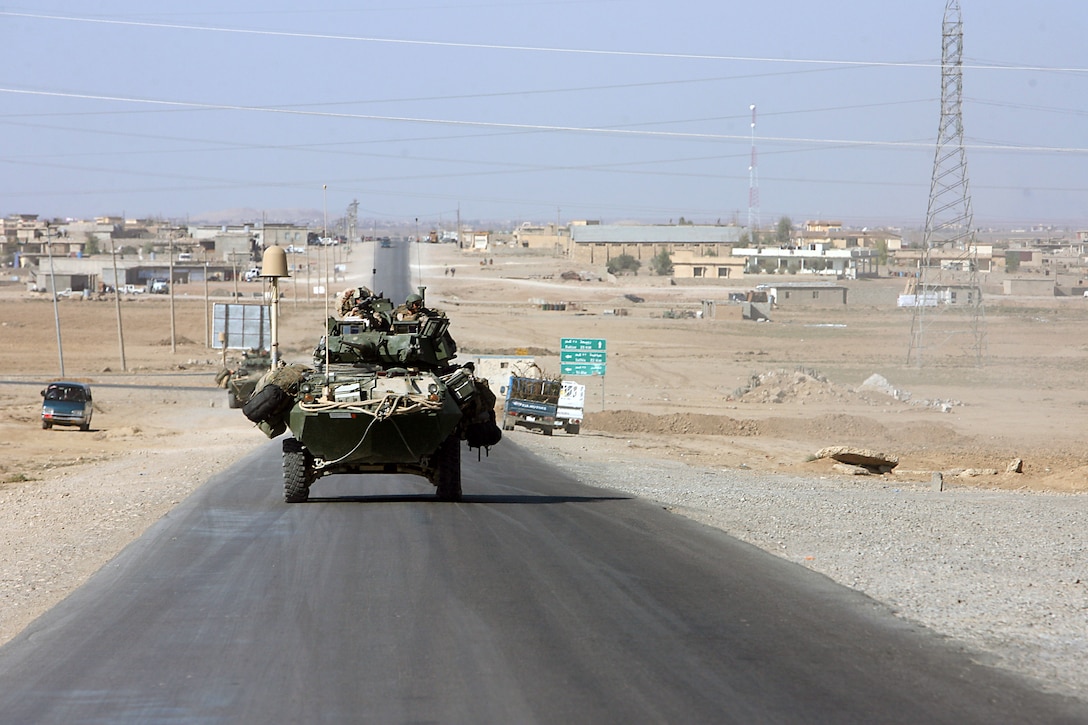 – Marines from Company D, 1st Light Armored Reconnaissance Battalion, 1st Marine Division, roll past a small village Nov. 12. It wasn’t long after breakfast that Lance Cpl. Russell L. Pope, 21, Livingston, Texas, was sitting in the cold in the back of a Light Armored Vehicle thumbing the safety of his loaded rifle. He wasn’t nervous, he said, just on edge. Like the Iraqi people seemed to be in the market of the seemingly anti-coalition town of T’all Uhwaynat, a main trade hub leading from Syria to Mosul. “Your spider senses, they kick in, and you’re a lot more alert, you’re paying a lot more attention to everything around you,” said Pope, scout, Company D, 1st Light Armored Reconnaissance Battalion, 1st Marine Division. “We rolled in and the whole market stopped, everybody stopped, and they all started staring at us.” Luckily Pope’s thumb never switched the weapon off “safe.” That punch never came. Any enemy, if present, stayed low and skipped out on Bibeau’s beat down. Though the “Diablos” may not have fired a round, they still considered their mounted patrol through T’all Uhwaynat a successful strike against the enemy. Until the Marines arrived, there was little Coalition force presence in the town. It’s likely that an insurgent cleric may be preaching anti-Coalition rhetoric, or that insurgents have threatened the town’s people.Whatever the reason villagers gave Marines the cold shoulder, the Marines intend to free them from any oppression. If the town is a resupply route for the insurgents, it won’t be long before the Diablos take it away. The Marines of Company D, 1st LAR, make up one element of the first Marine Air Ground Task Force outside Anbar in Iraq since 2004. They traveled to the Nineweh province to kick off Operation Defeat Al Qaeda in the North II, an operation aimed at stamping out the insurgency just west of the restive city of Mosul.