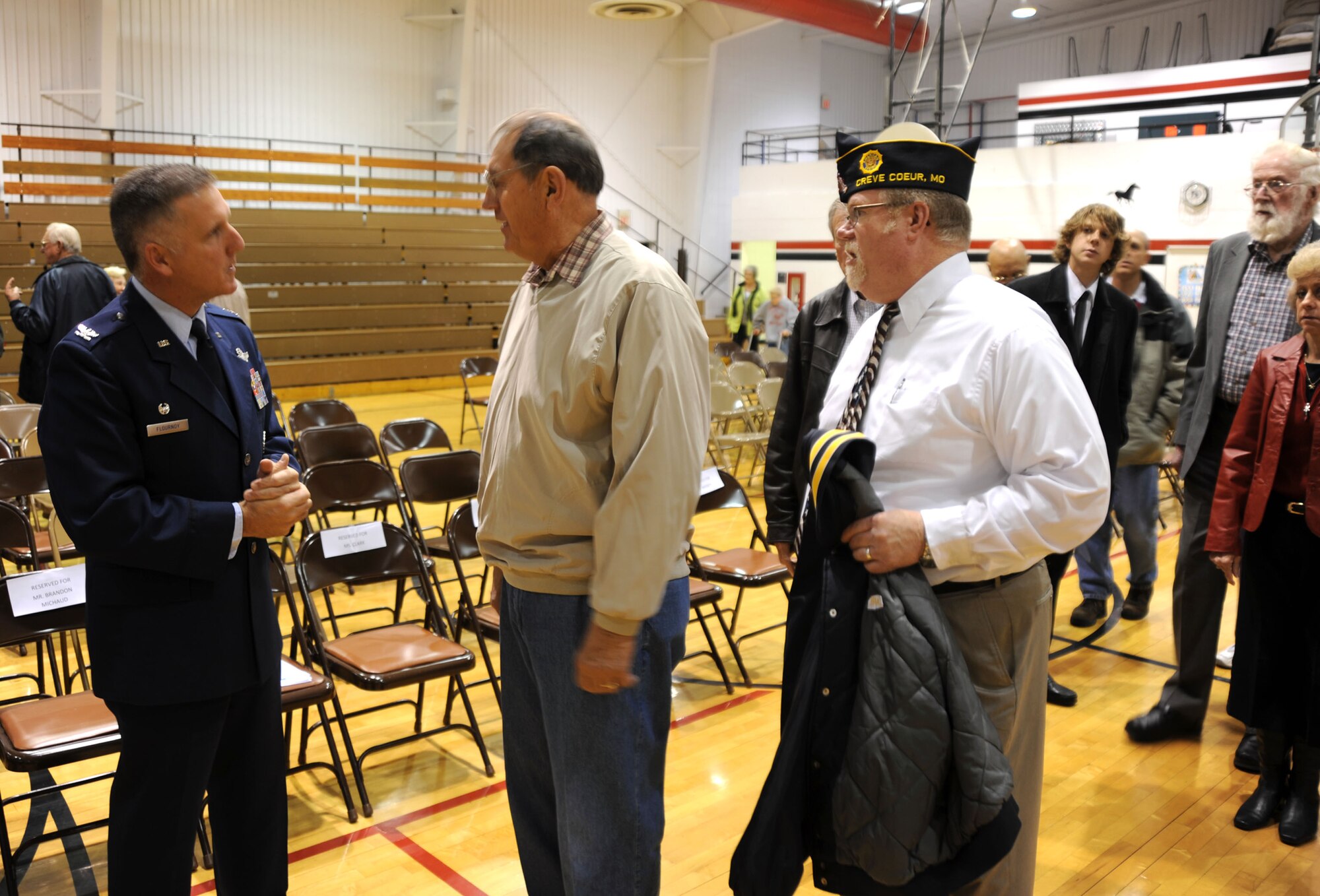 Members of the O'Fallon, Missouri community wait in line to talk with Col. John C. Flournoy, Jr., after his Veteran's Day presentation to students, faculty and the general public at the South Middle School of Fort Zumwalt's school district.  The Colonel is the commander of the 932nd Airlift Wing, Air Force Reserve, located at Scott Air Force Base near Belleville, Ill.  (U.S. Air Force photo/Tech. Sgt. Gerald Sonnenberg)