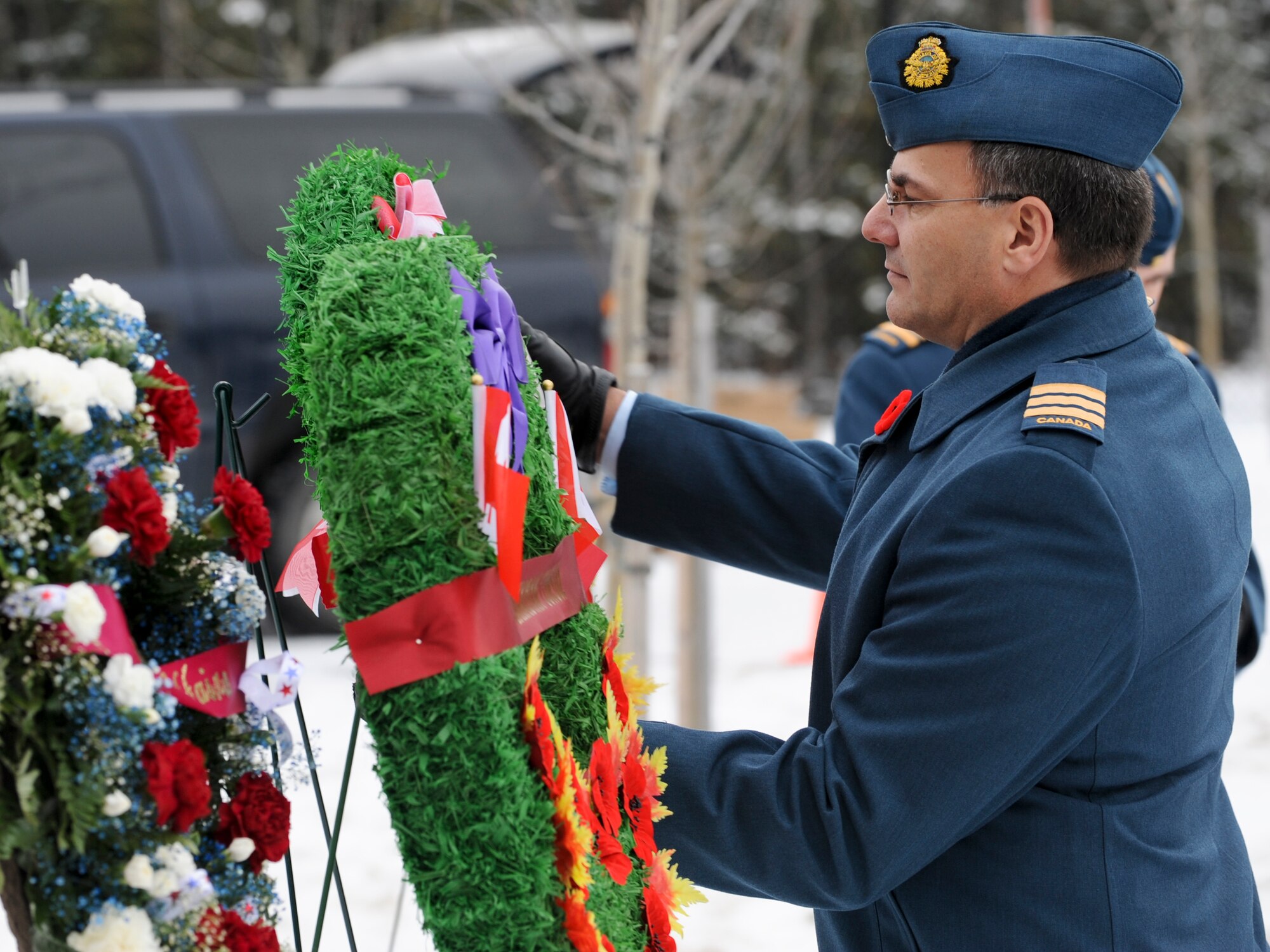 FORT RICHARDSON, Alaska -- Lt. Col. Jim McLean, Canadian Component commanding officer on Elmendorf Air Force Base, places a wreath in honor of fallen warriors during the Veteran Day Memorial Ceremony at Fort Richardson National Cemetery Nov. 11. The ceremony hosted by the Canadian Forces represented all servicemembers who fought in America's past and present wars. (U.S. Air Force photo/Staff Sgt. Joshua Garcia)