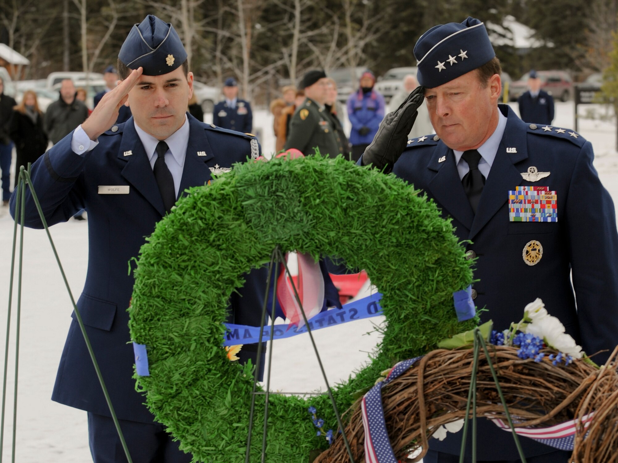 FORT RICHARDSON, Alaska -- Maj. Thomas Wolfe (left) and Lt. Gen. Dana Atkins (right), 11th Air Force commander, salute a wreath during the Veterans Day ceremony at Fort Richardson National Cemetery Nov. 11. The ceremony commemorated all those who paid the ultimate sacrifice for their country. Air Force alongside Army and Canadian forces were present for the ceremony. (U.S. Air Force photo/Staff Sgt. Joshua Garcia)