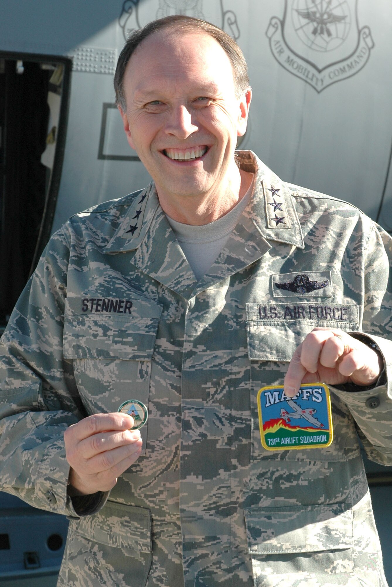 Lt. Gen. Charles Stenner, Jr., proudly presents his modular airborne firefighting system, or 'MAFFS' coin and patch Nov. 12 after a system's orientation flight at Peterson Air Force Base, Colo. General Stenner, commander of the Air Force Reserve, visited the base to gain a better understanding of the wing and its sister unit, the 310th Space Wing, based at Schriever AFB, Colo. Together with a demonstration flight on the firefighting system, the general also held a question-and-answer session at the base's club. The MAFFS system is used in wild land firefighting missions when called up to support state officials in the U.S. when all other firefighting methods have been exhausted. (U.S. Air Force photo/Ann Skarban)