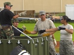 Members of the 724th Aeromedical Staging Flight helped augment the 433rd Medical Group during the Lackland Reservists' overseas annual tour July 2008 at Andersen Air Force Base, Guam. The 433rd MDG spent much of their time inventorying and testing Contigency Aeromedical Staging Facility War Reserve Materiel. The CASF is a unique, modular aeromedical staging facility that is designed to support world-wide expeditionary contingencies.

From left - Unidentified 433rd MDG member, Staff Sgt. Jaclyn Santos, Tech. Sgt. Edward Villanueva and Tech. Sgt. Mae Estoy.

(Air Force courtesy photo)