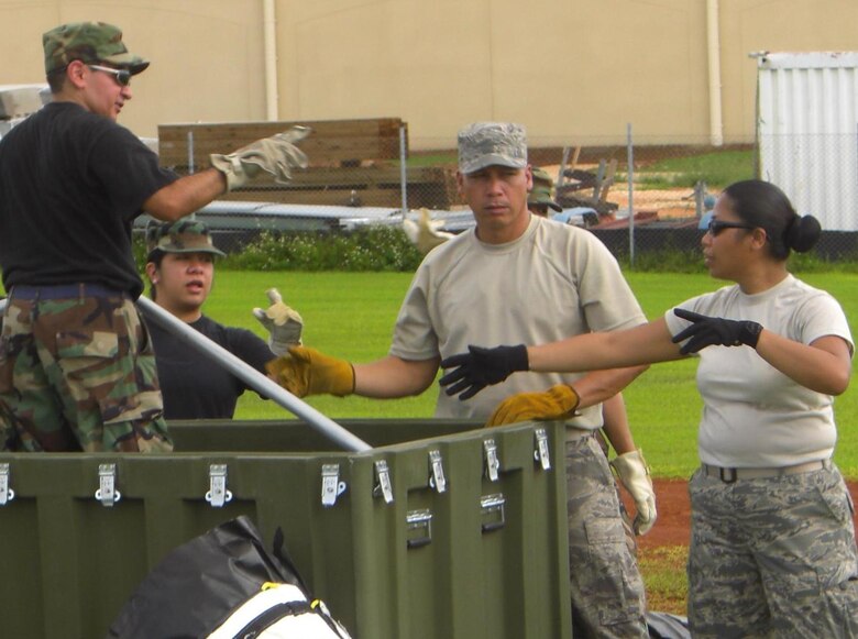 Members of the 724th Aeromedical Staging Flight helped augment the 433rd Medical Group during the Lackland Reservists' overseas annual tour July 2008 at Andersen Air Force Base, Guam. The 433rd MDG spent much of their time inventorying and testing Contigency Aeromedical Staging Facility War Reserve Materiel. The CASF is a unique, modular aeromedical staging facility that is designed to support world-wide expeditionary contingencies.

From left - Unidentified 433rd MDG member, Staff Sgt. Jaclyn Santos, Tech. Sgt. Edward Villanueva and Tech. Sgt. Mae Estoy.

(Air Force courtesy photo)