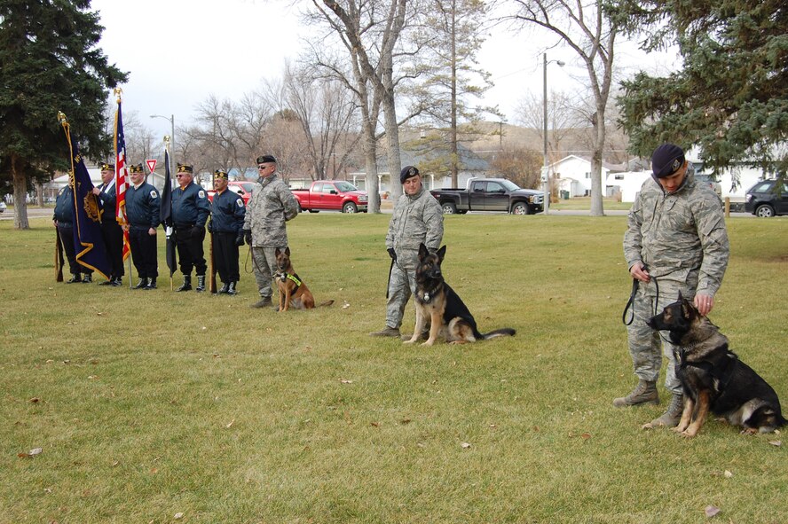 Members of Malmstrom's K-9 unit stand next to the Fort Benton veterans color guard before a Military Working Dog memorial dedication ceremony Nov. 11. (U.S. Air Force photo/Senior Airman Emerald Ralston)