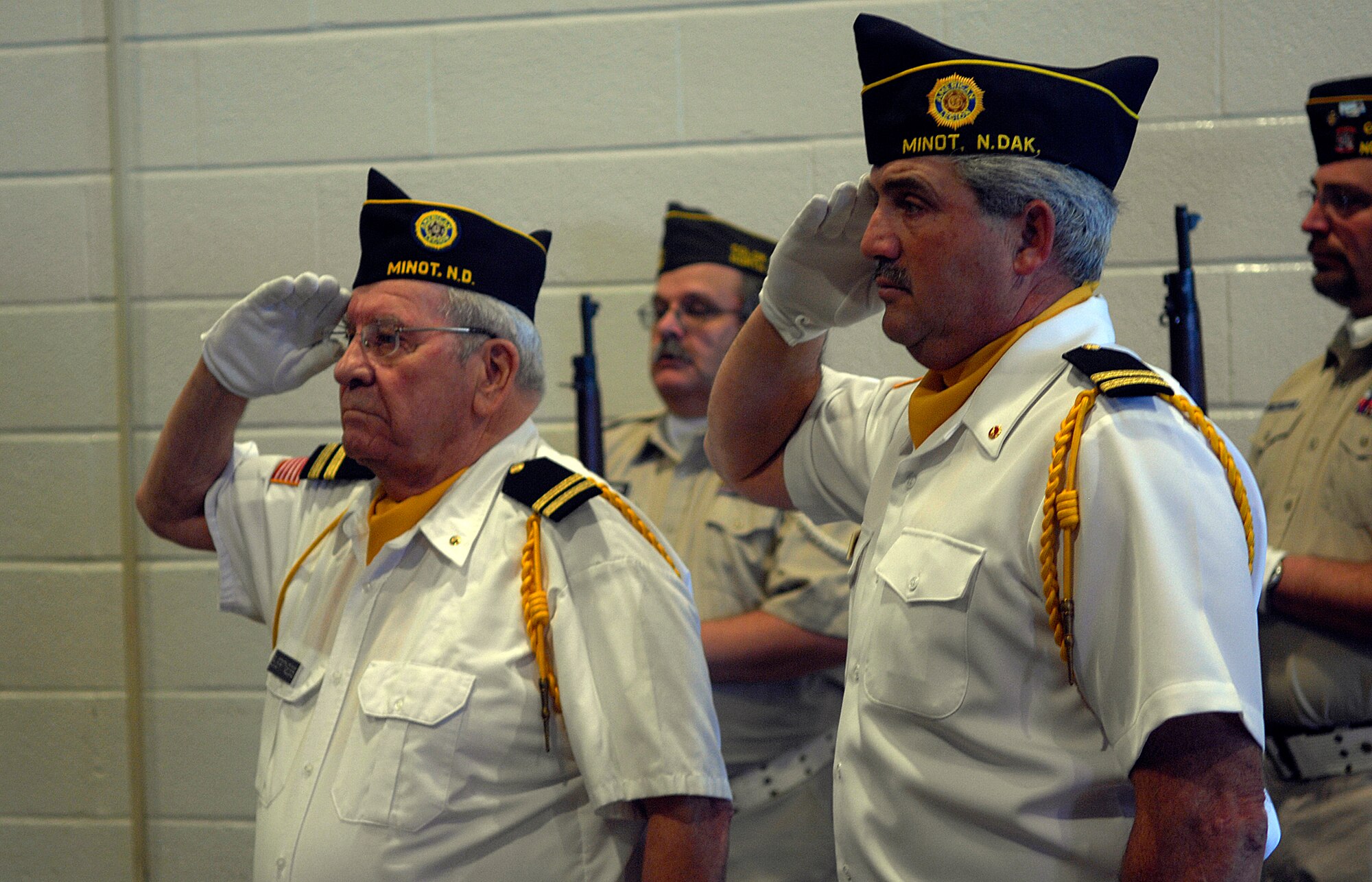 MINOT, N.D. -- Members of local veterans organizations salute the flag during  the Minot’s Veterans Day program held at the Minot Municipal Auditorium here Nov. 11. Minot’s program, which is an annual event, was organized by Disabled American Veterans Chapter 4, in conjunction with other veterans organizations and auxiliaries, and included the Minot High School-Magic City Campus Band performing the national anthem, a salute to the armed forces, and a special patriotic selection called “Missing Man.” (U.S. Air Force photo by Senior Airman Joe R. Rivera Jr.)