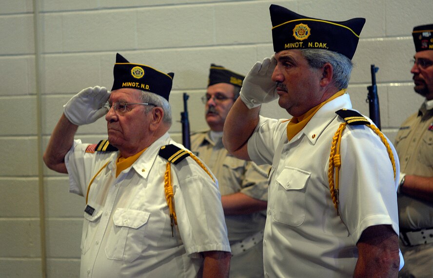MINOT, N.D. -- Members of local veterans organizations salute the flag during  the Minot’s Veterans Day program held at the Minot Municipal Auditorium here Nov. 11. Minot’s program, which is an annual event, was organized by Disabled American Veterans Chapter 4, in conjunction with other veterans organizations and auxiliaries, and included the Minot High School-Magic City Campus Band performing the national anthem, a salute to the armed forces, and a special patriotic selection called “Missing Man.” (U.S. Air Force photo by Senior Airman Joe R. Rivera Jr.)