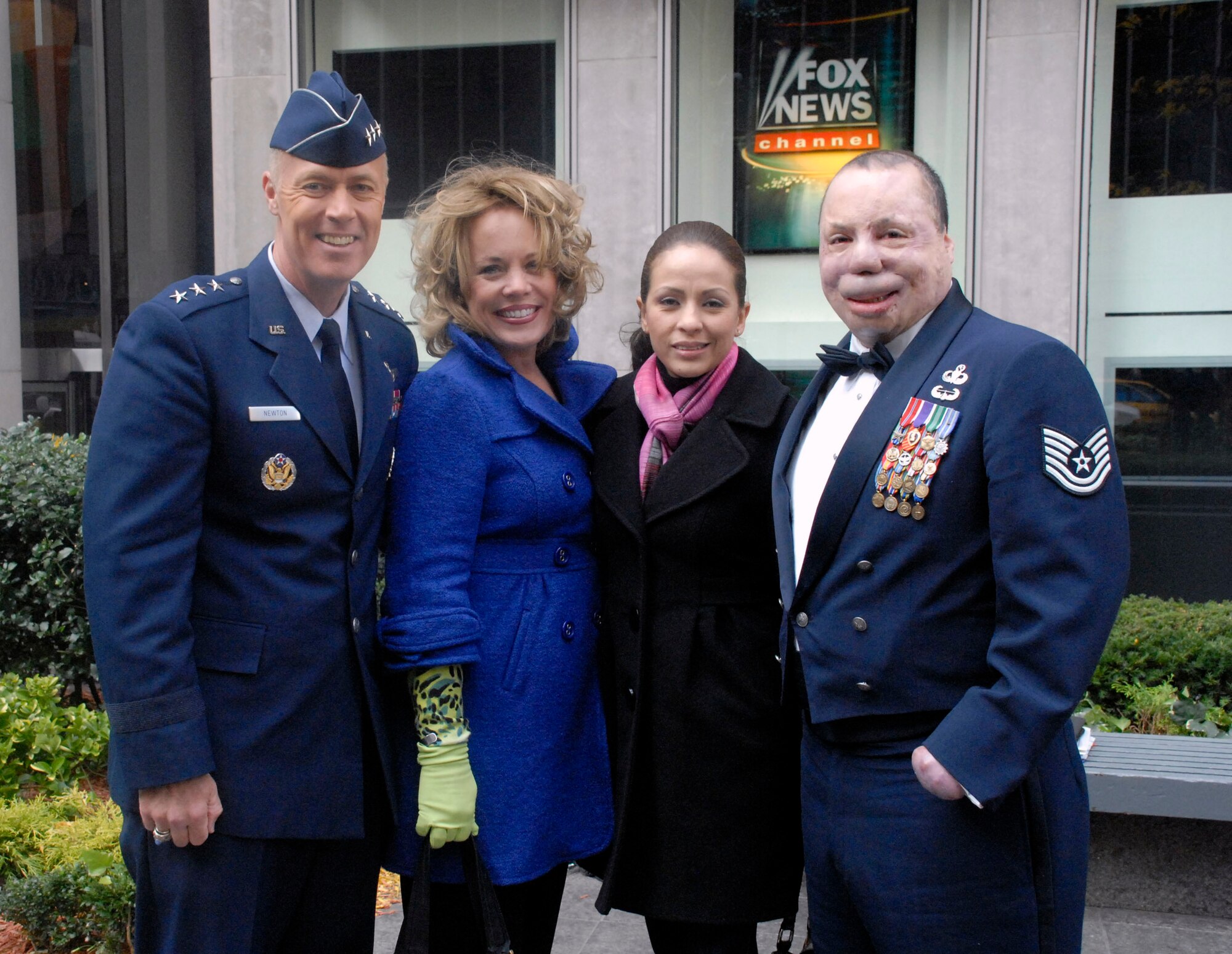 Lt. Gen. Richard Y. Newton III, Jody Newton, Carmen Del Toro and Tech. Sgt. Israel Del Toro stand outside Fox News following an interview with the men on "Warrior Care Month" Nov. 10 in New York City. General Newton is the deputy chief of staff for manpower, personnel and services at the Pentagon. Sergeant Del Toro was a joint tactical air control party operator who was wounded Dec. 4, 2005, when the Humvee he was riding in rolled over a roadside bomb in Afghanistan. (U.S. Air Force photo/Staff Sgt. Monique Randolph) 
