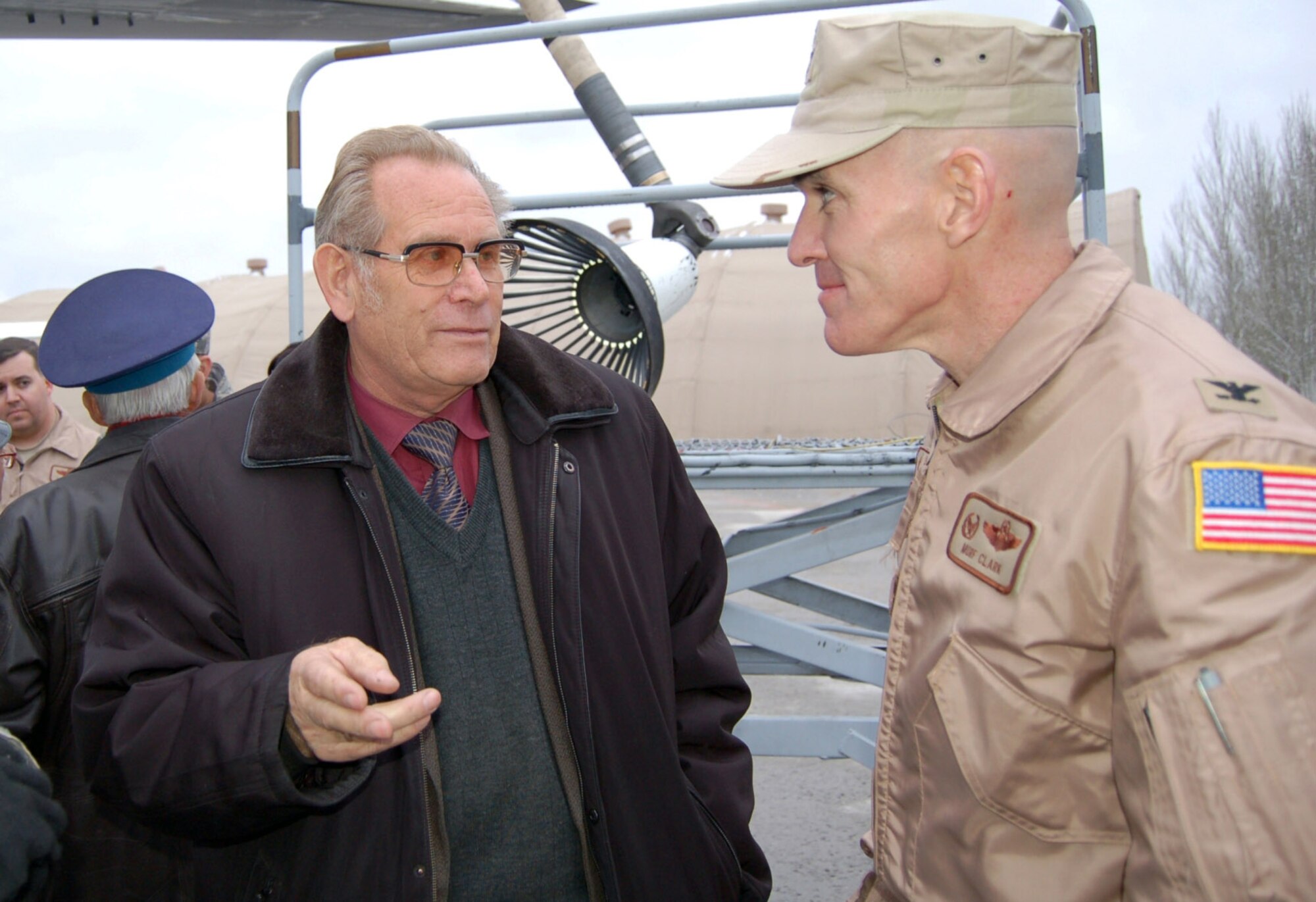 Retired Soviet air force Capt. Valeri Kolodyzahni talks to Col. Murray Clark about his ejection from a MiG-15 over Damascus, Syria, in 1962; an event which ended a dynamic military career that included meeting the first man in space, Yuri Gagarin, while at test pilot school. The base hosted the veterans for an appreciation day visit, which included a tour, dinner and the kickoff of a new program established to assist them with some of their living expenses. Colonel Clark is the 376th Expeditionary Operations Group commander. (U.S. Air Force photo/Maj. Damien Pickart)