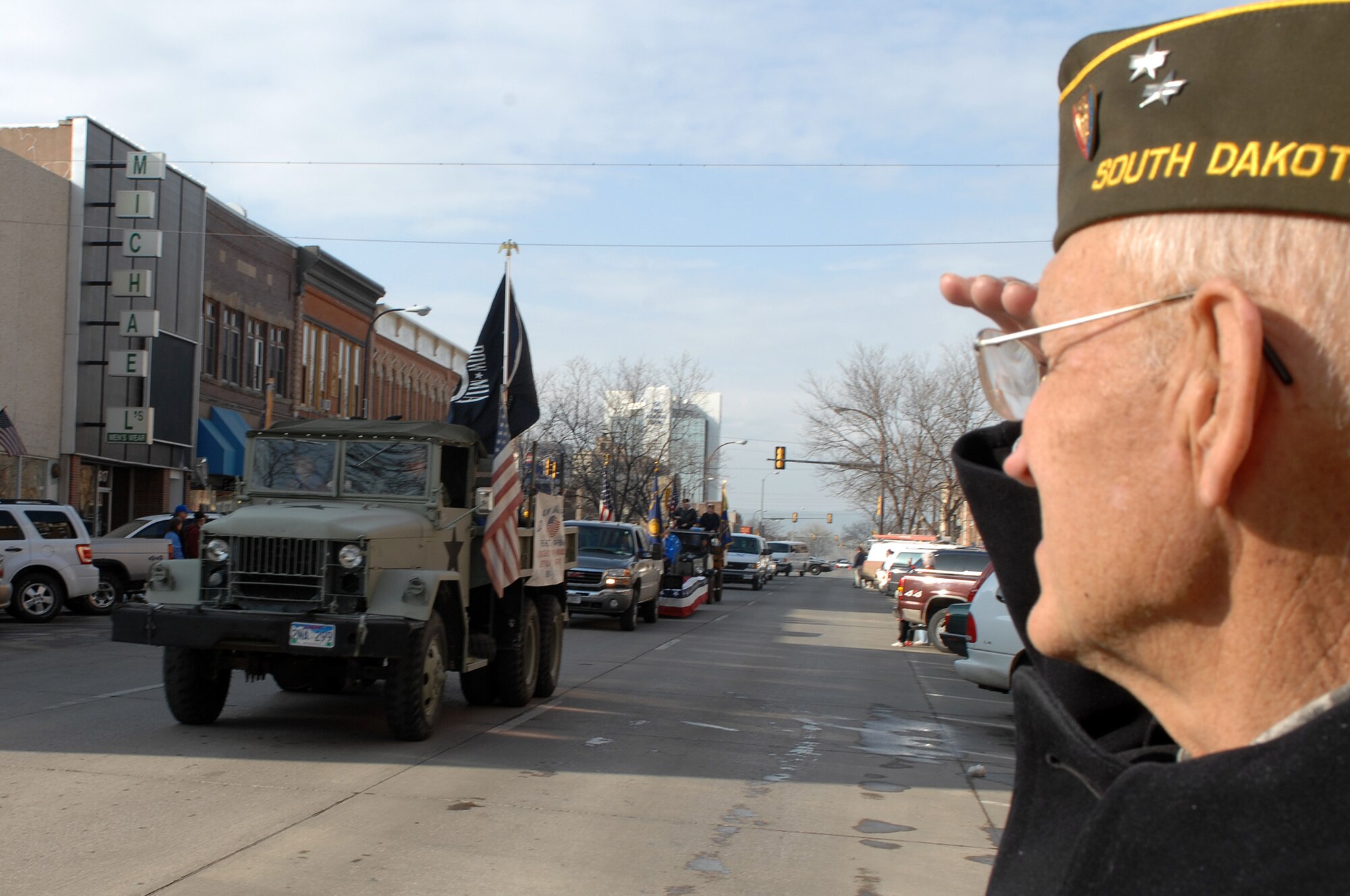 Donovan Wagner, World War II veteran, salutes as a military vehicle with the American flag and POW/MIA flag pass during a Veterans Day parade in Rapid City, S.D., Nov. 11. Veterans Day honors those who have served and are serving in the military. (U.S. Air Force photo/Airman 1st Class Joshua J. Seybert)