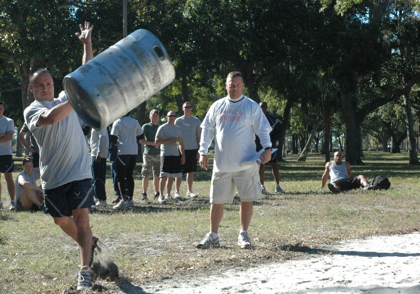 Staff Sgt. Chris Buckius, 325th Maintenance Operations Squadron training manager, throws a keg as part of the keg toss portion of the strongest squadron contest during wing sports day here Monday.   Each team was required to have all three members toss an empty keg for a combined distance for the competition.  (U.S. Air Force photo by Staff Sgt. Timothy Capling)  