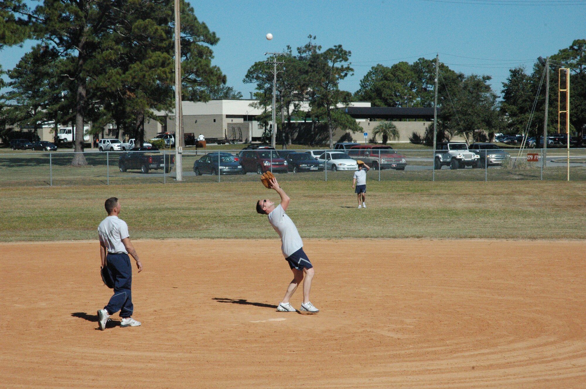 As his team watches intently, Staff Sgt. Matt Compton, 372nd Training Squadron F-15 Field Training Detachment instructor, prepares to catch a fly ball. The tenant unit instructors squared off against the Mission Ready Airmen during Sports Day here. (U.S. Air Force photo by Staff Sgt. Vesta M. Anderson)