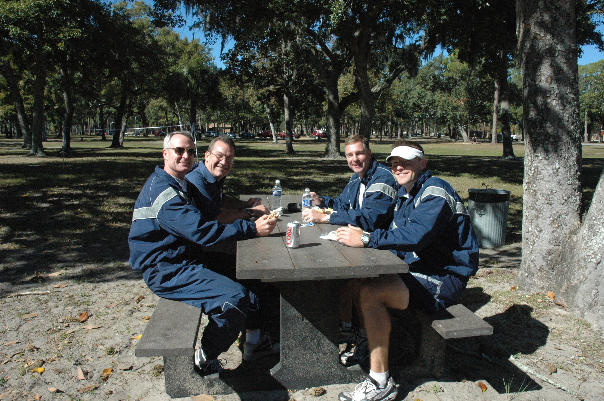 (From left) Gen. Darryl Roberson, 325th Fighter Wing commander, retired Col. James Frishkorn, 325th Mission Support Group deputy directory, Col. David Zeh, 325th Mission Support Group commander, and 1st Lt. Patrick Wilkinson, 325th Force Support Combat Support flight commander, enjoy lunch together during the Sports Day cook out. (U.S. Air Force photo by Staff Sgt. Vesta M. Anderson)