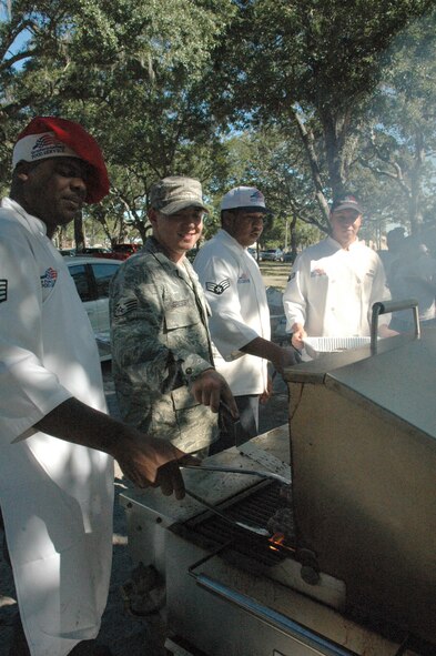 325th Force Support Squadron food technicians, (from left) Staff Sgts. Curtis Moore and Seth Gregory, Senior Airman Dennis Beck and Airman 1st Class Elias Peredo, work the grill during Sports Day. (U.S. Air Force photo by Staff Sgt. Vesta M. Anderson) 
