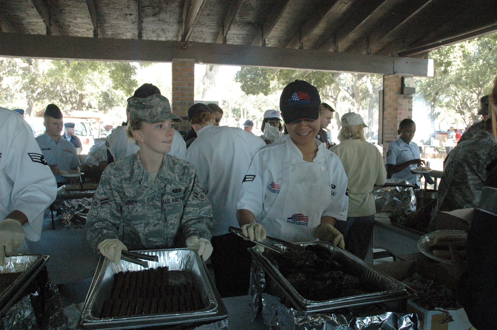 Airmen 1st Class Jessica Lundy and Sierra Pritchard, 325th Force Support Squadron food technicians, serve hot dogs and hamburgers to Team Tyndall. (U.S. Air Force photo by Staff Sgt. Vesta M. Anderson)