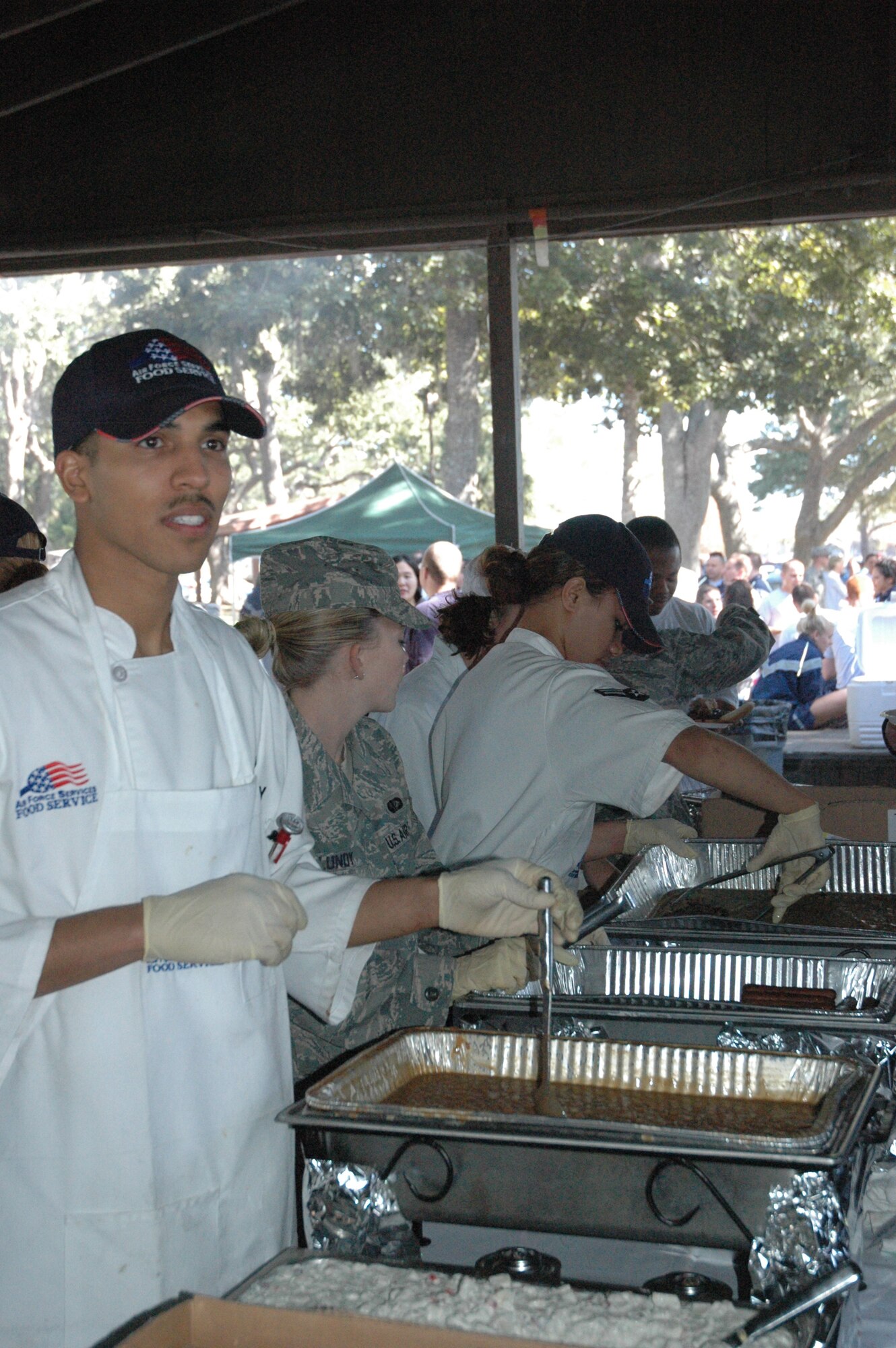 Senior Airman Dennis Murphy, 325th Force Support Squadron food technician, serves Airmen at the Sports Day cook out. (U.S. Air Force photo by Staff Sgt. Vesta M. Anderson)