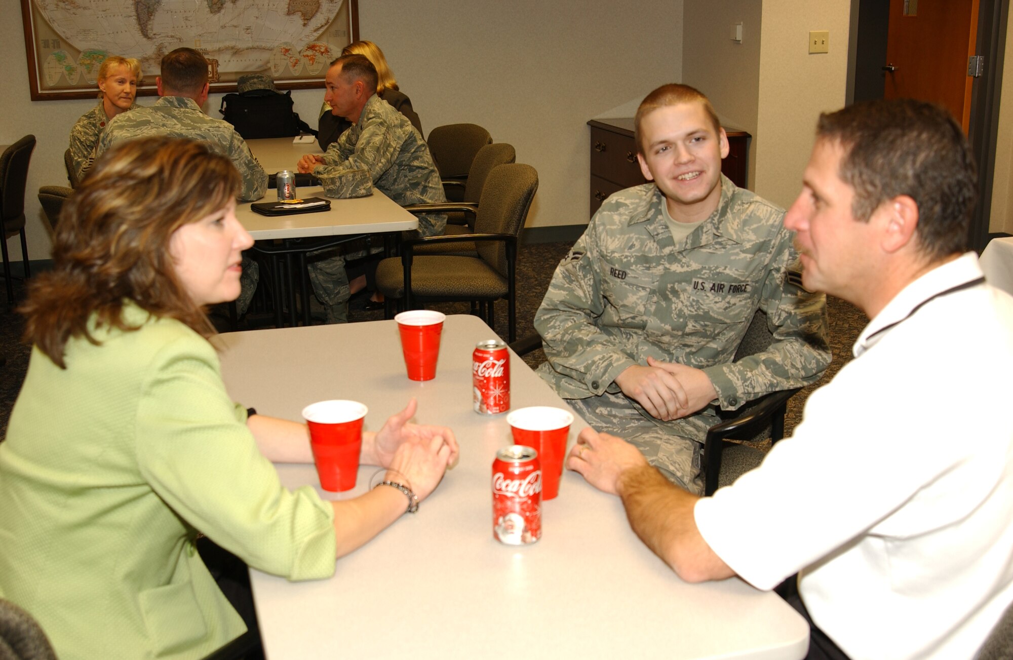 SCOTT AIR FORCE BASE, Ill. -- Airman 1st Class Kyle Reed, 375th Communications Support Squadron computer programmer, meets his Helping Our Servicemembers Transition program family for the first time at the Airman and Family Readiness Center. Airmen and HOST families were matched based on similar interests to provide an extended family for first-term Airmen. The HOST program is a first for Scott and the Air Force. (U.S. Air Force photo/Airman 1st Class Amber Kelly-Woodward) 