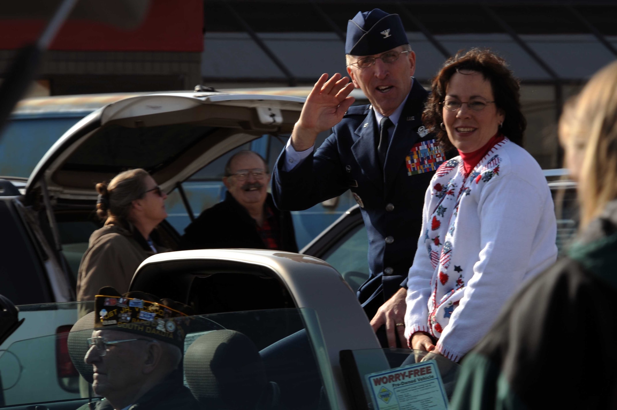 Col. Scott Vander Hamm, 28th Bomb Wing commander, and wife, Joanna, wave at spectators during a parade in downtown Rapid City, S.D., Nov. 11. Rapid City hosted this parade, which took place on Main Street, in honor of Veterans Day. (U.S. Air Force photo/Airman Corey Hook)