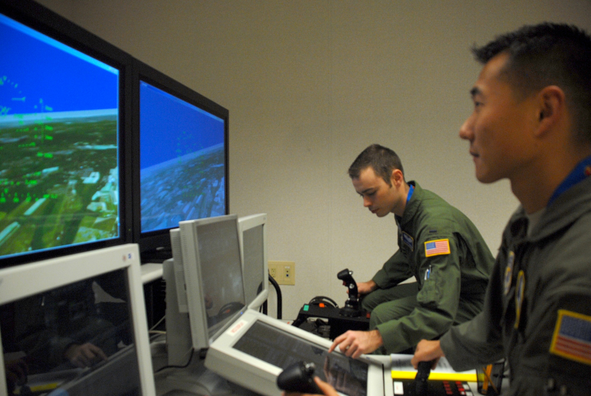 (Right) 1st Lt. Jay Weaver and 1st Lt. Matthew Tarnowski, 3rd Airlift Squadron first pilots, train using Dover?s new Reconfigurable Desktop Simulator.  The new system allows pilots and loadmasters to train at Dover instead of traveling to New Jersey or Mississippi.  (U.S. Air Force photo/Staff Sgt. Chad Padgett)