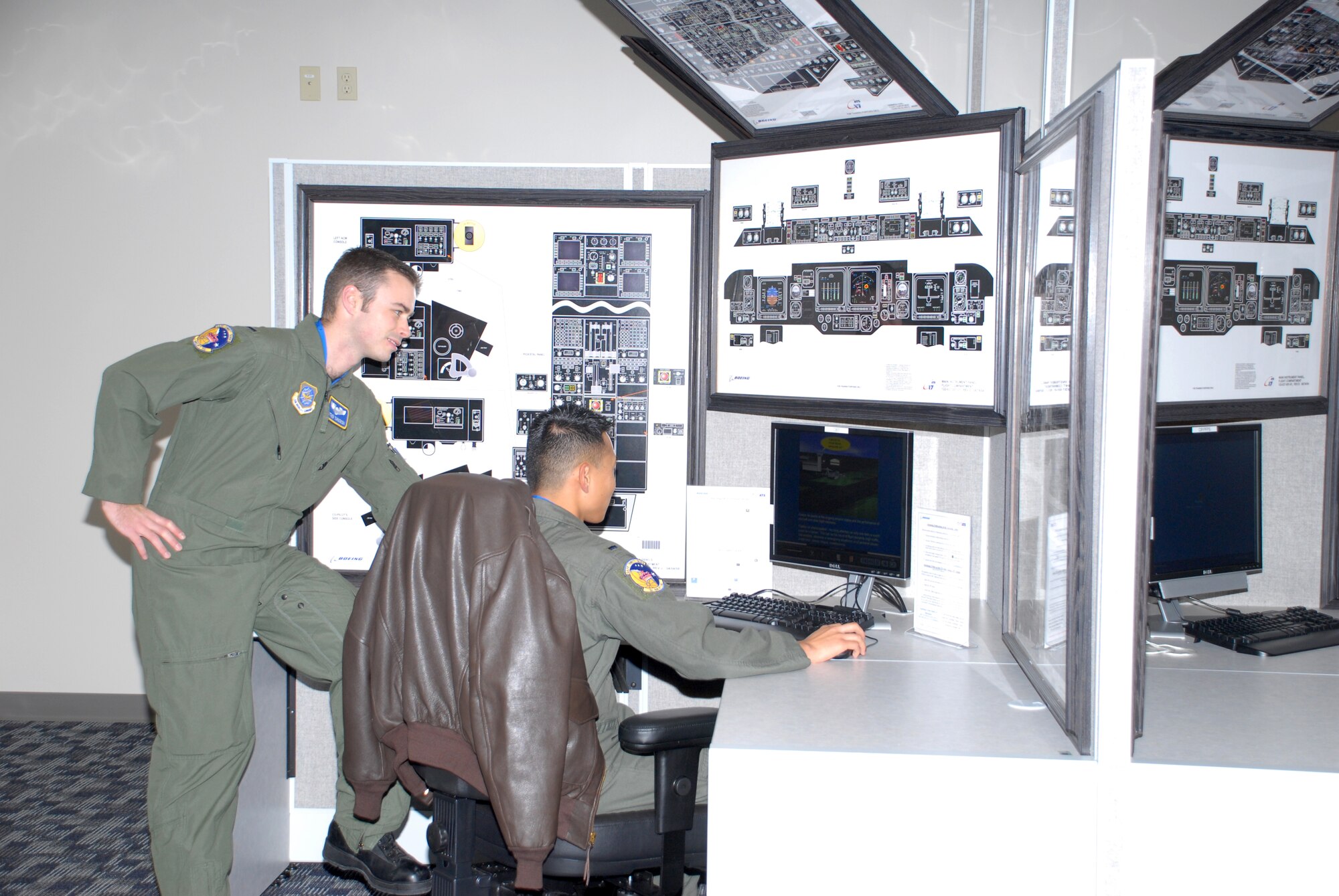 (Left) 1st Lt. Matthew Tarnowski and 1st Lt. Jay Weaver, 3rd Airlift Squadron first pilots, train using Dovers? new Boeing Learning Center.  The new system allows pilots and loadmasters to train at Dover instead of traveling to New Jersey or Mississippi.  (U.S. Air Force photo/Staff Sgt. Chad Padgett)