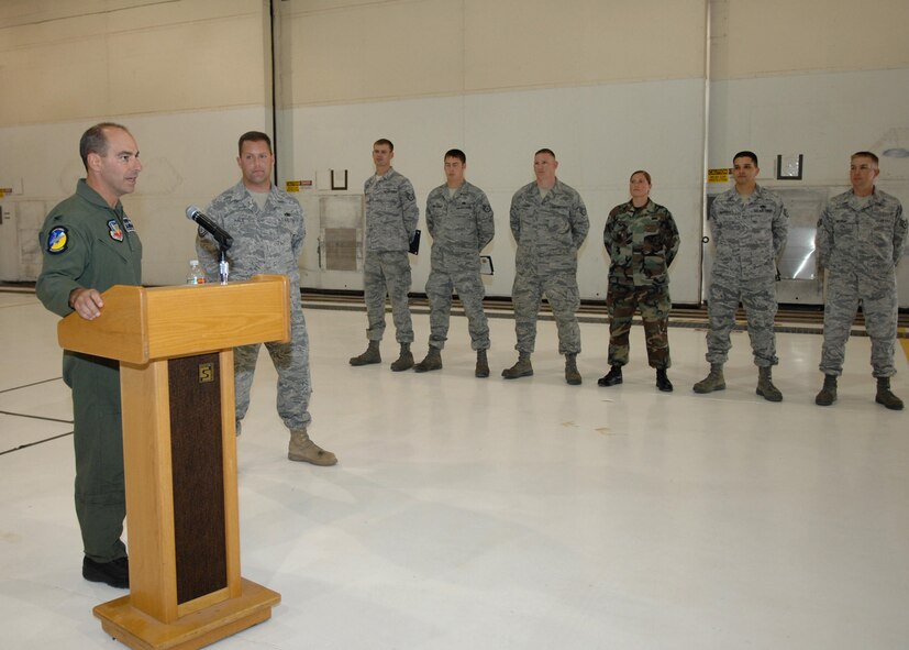 Col. Jeff Harrigian, 49th Fighter Wing commander, gives a speech at the Dedicated Crew Chief ceremony in hangar bay 2 at Holloman Air Force Base, N.M., Nov. 7. All six Airmen gathered at the hangar for their recognition in becoming Holloman's Dedicated Crew Chiefs. (U.S. Air Force photo/Airman 1st Class Veronica Salgado)