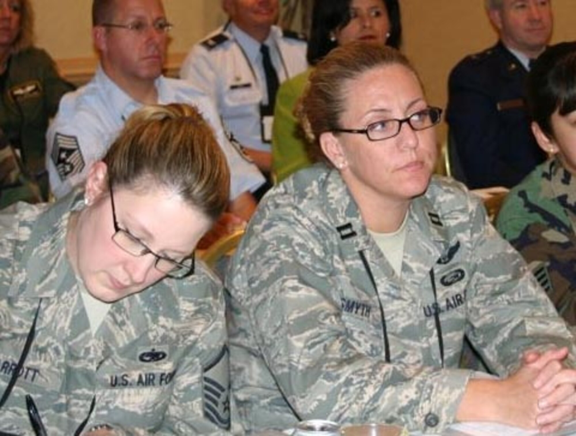 MCGUIRE AIR FORCE BASE, N.J. -- Master Sgt. Megan Parrot, left and Capt.Kelly Smyth, both members of the 514th Air Mobility Wing here, listen to a speaker at the AF Reserve Command Human Resources Development Council Workshop in Atlanta held in October. The bi-annual workshop featured sessions on mentoring, diversity, career progression, a first-term Airman's panel and a senior leader's panel. 